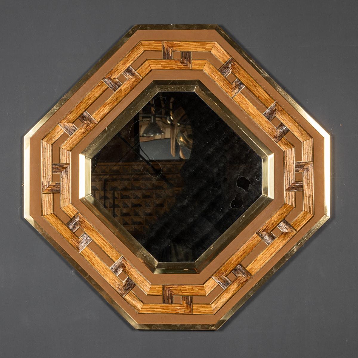 Crafted in the mid-20th century, Gabriella Crespi's octagonal mirror showcases a striking geometric design fashioned from reeds and bamboo, elegantly encased in a brass frame. Its adaptable nature allows for hanging it as either a square or at an