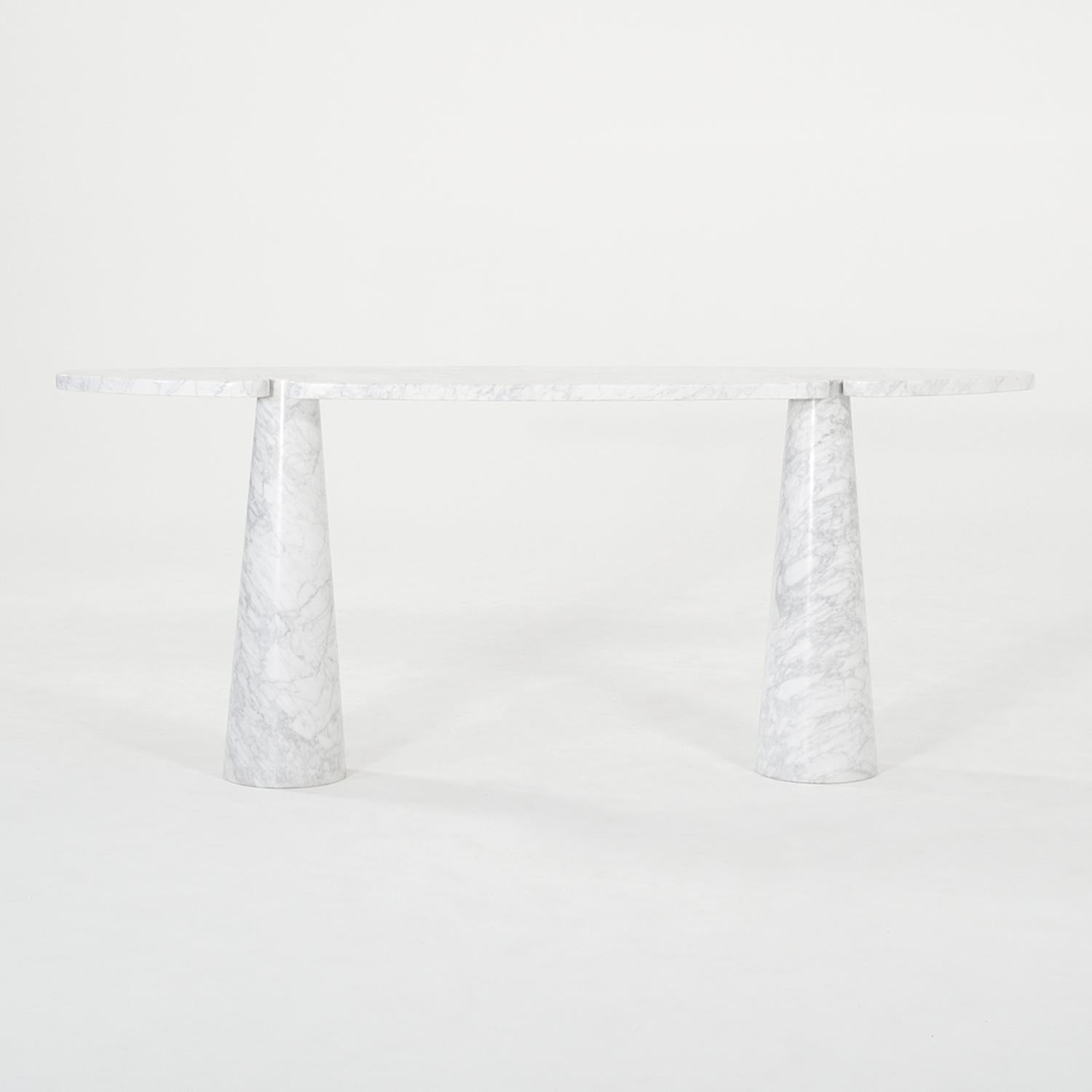 A vintage Mid-Century modern Italian freestanding console table made of hand crafted Carrara marble, designed by Angelo Mangiarotti and produced by Skipper in good condition. The half rounded, tall Eros end table has no joints, only an interlocking