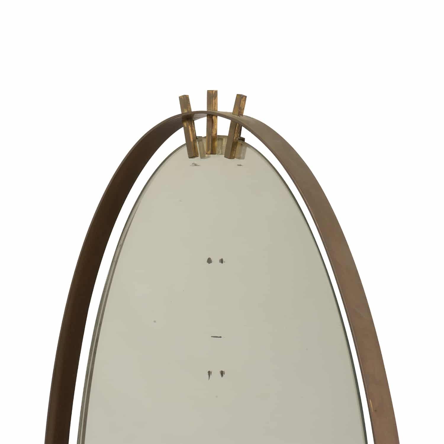 An oval, vintage Mid-Century Modern Italian wall mirror made of hand crafted lacquered metal with its original mirror glass, produced by Santambrogio & De Berti in good condition. The mirror is enhanced by detail brass décor. Minor fading on the