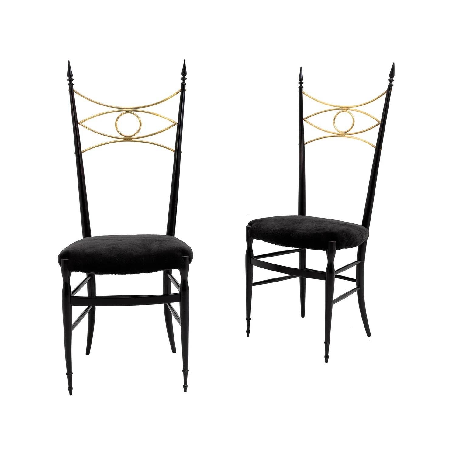 A black-gold, vintage Mid-Century Modern Italian pair of high sculptural dining room chairs made of hand crafted ebonized Rosewood, designed most likely by Paolo Buffa in good condition. The detailed crafted side chairs are particularized with an