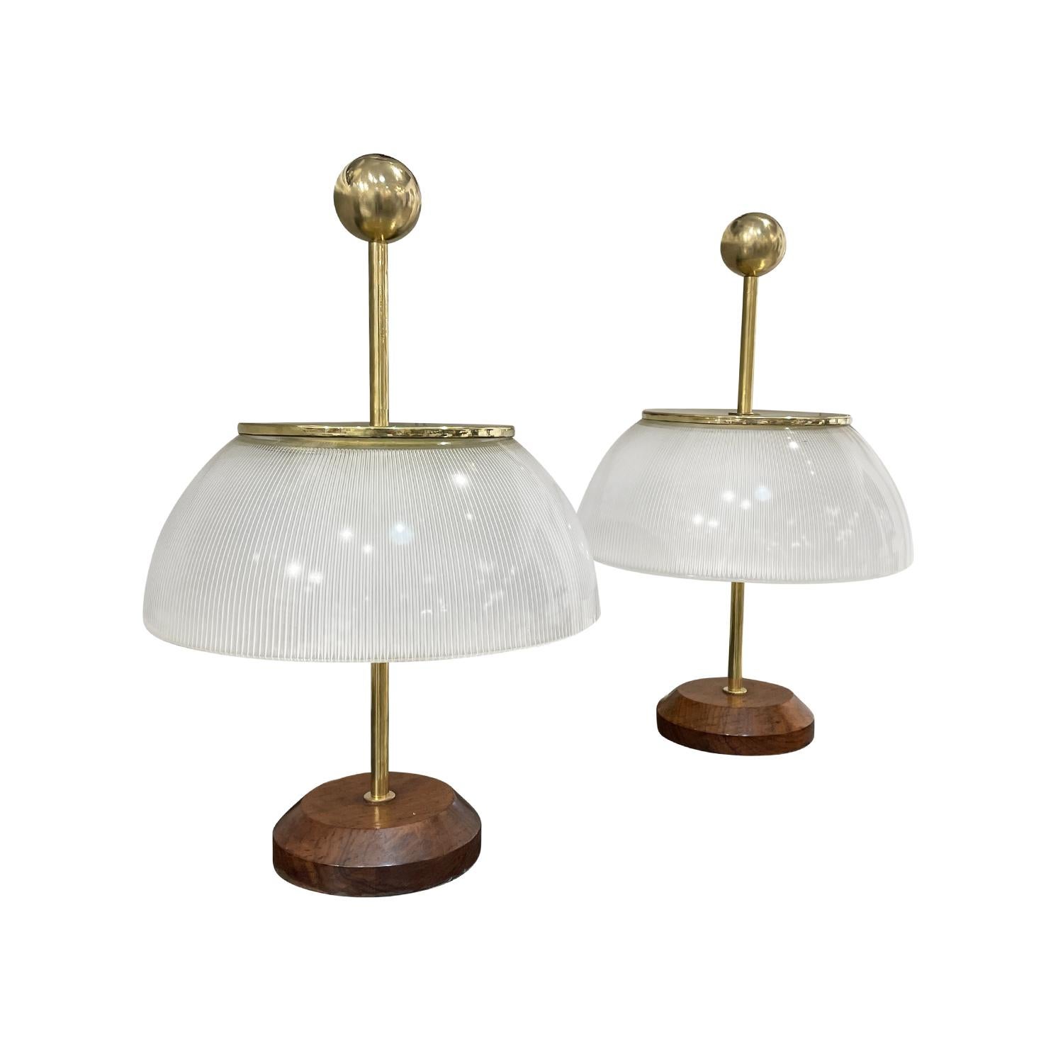 A vintage Mid-Century modern Italian pair of table lamps, model Alfa are made of hand blown Murano glass, designed by Sergio Mazza and produced by Artemide, in good condition. The slightly smoked round shades of the desk lights are enhanced by a