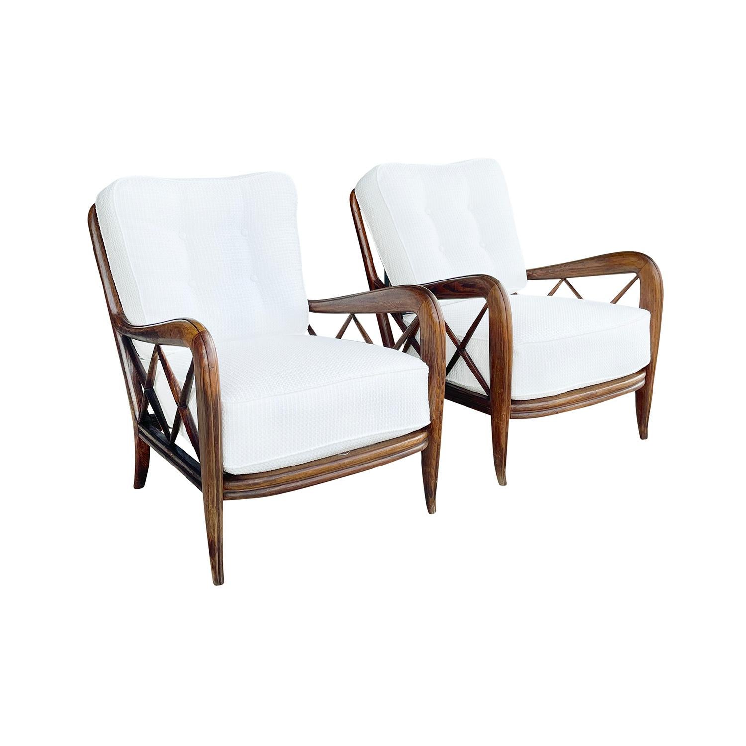 A vintage Mid-Century Modern Italian pair of armchairs made of hand carved beechwood, designed by Paolo Buffa, in good condition. The backrest of the lounge chairs are spindled with x-form slats arms with a button-tufted back cushion, standing on