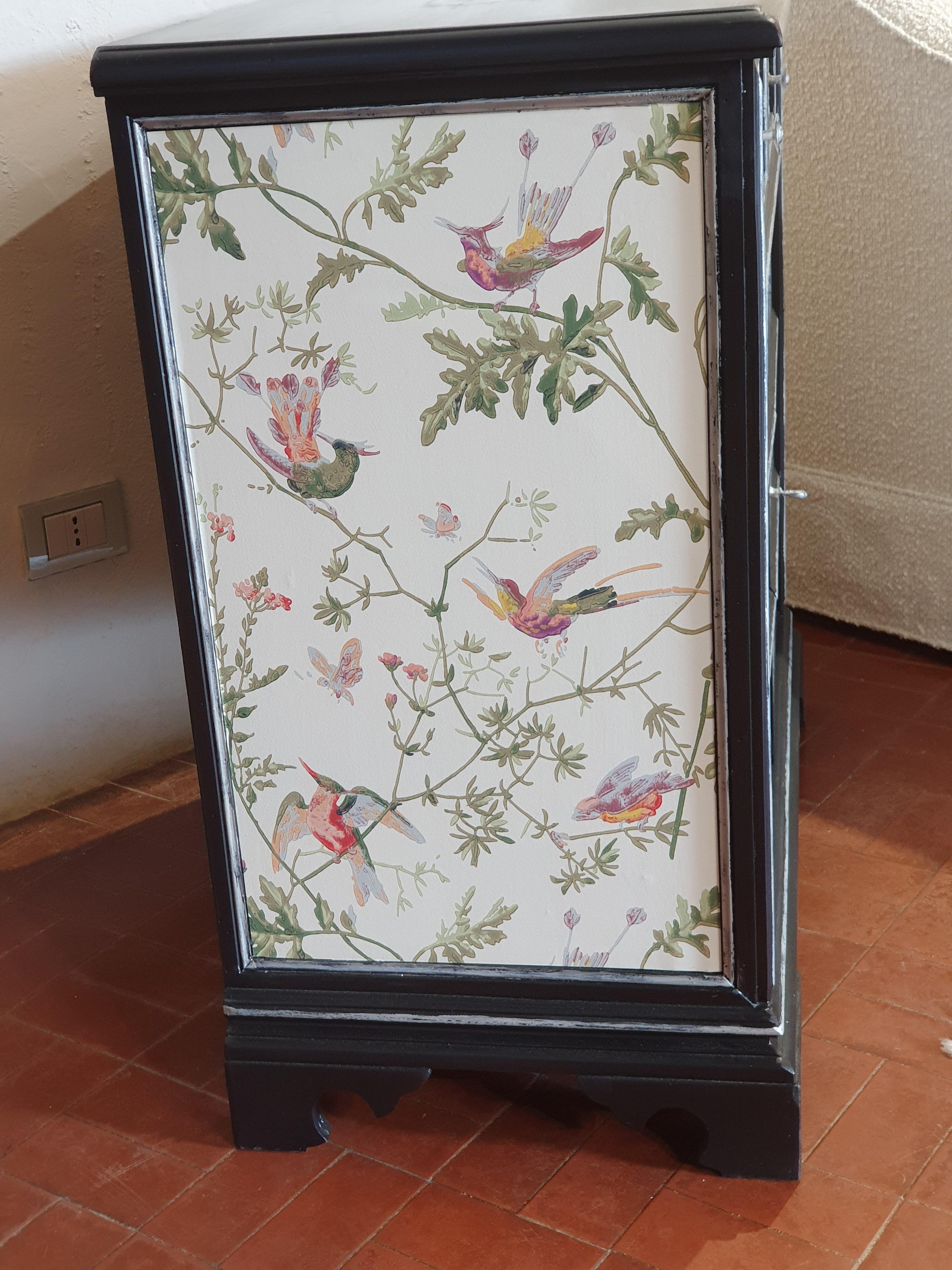 An elegant vintage Italian hand-painted wooden pair of buffet cabinets , hand-painted in black and silver color, ermined in Cole & Son wallpaper with birds and flowers. Each Italian credenzas are fitted with two doors and one drawer. The doors open