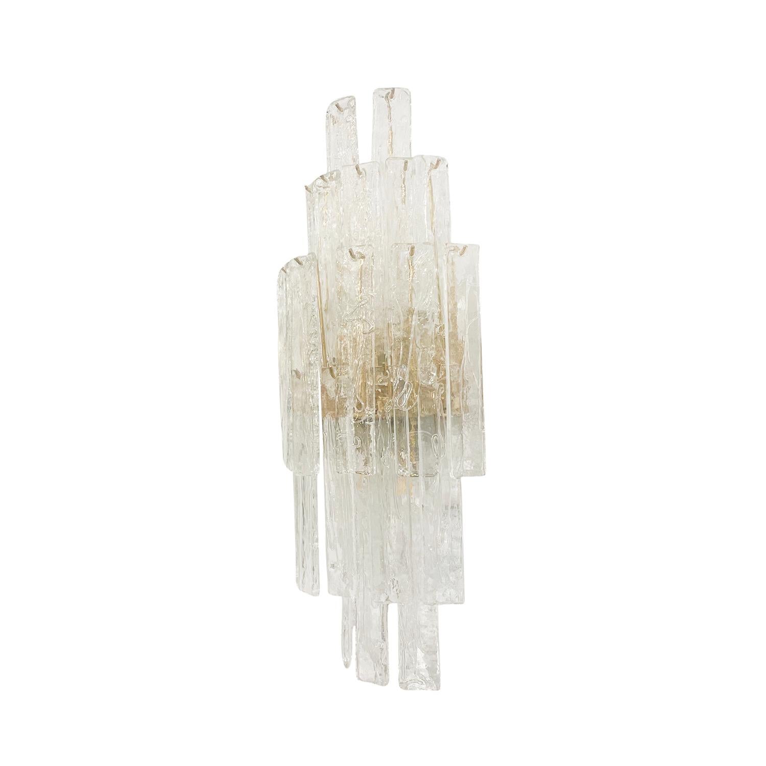 A vintage Mid-Century modern Italian pair of large wall appliques, sconces made of hand blown slightly smoked Pulegoso Murano glass, designed and produced by La Murrina in good condition. Each fixture is composed with twenty-six rectangular detailed