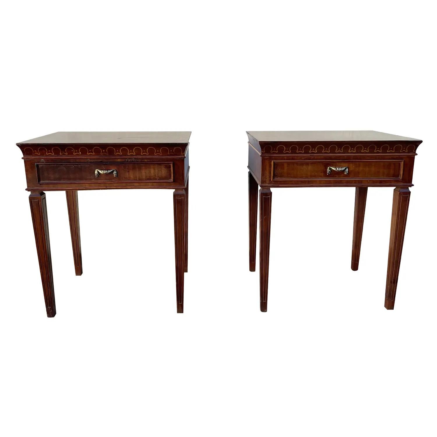 A light-brown, slim vintage Mid-Century modern Italian pair of nightstands, bedside tables made of hand carved Walnut with one small drawer composed with detailed brass pulls, handles. Designed by Paolo Buffa in good condition. The side tables are