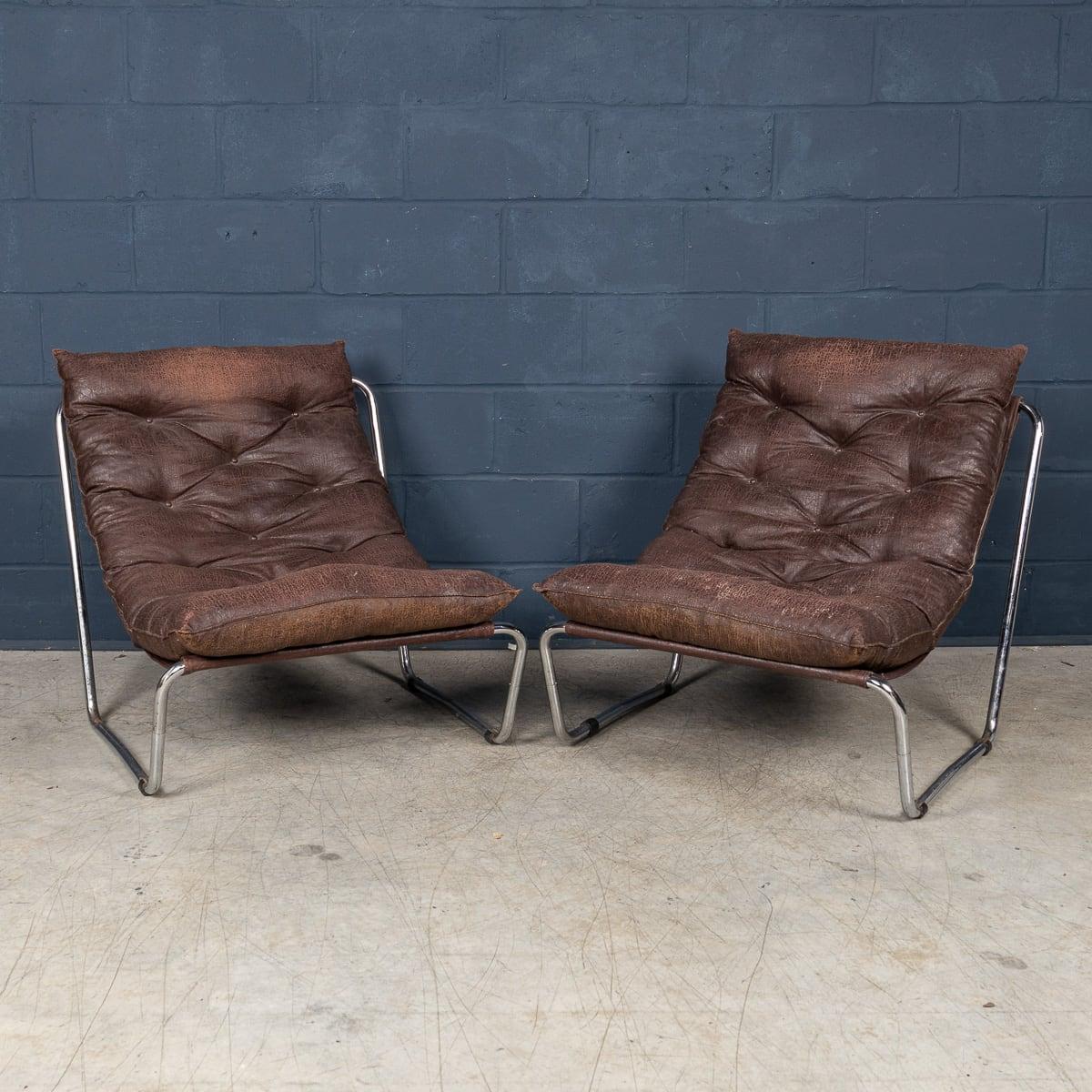 A pair of tubular-framed lounge chairs, Italy, circa 1980, showcasing the era’s innovative approach to modernist design. The sleek tubular metal frames emphasise clean lines and industrial aesthetics, reflecting influences from mid-century modern