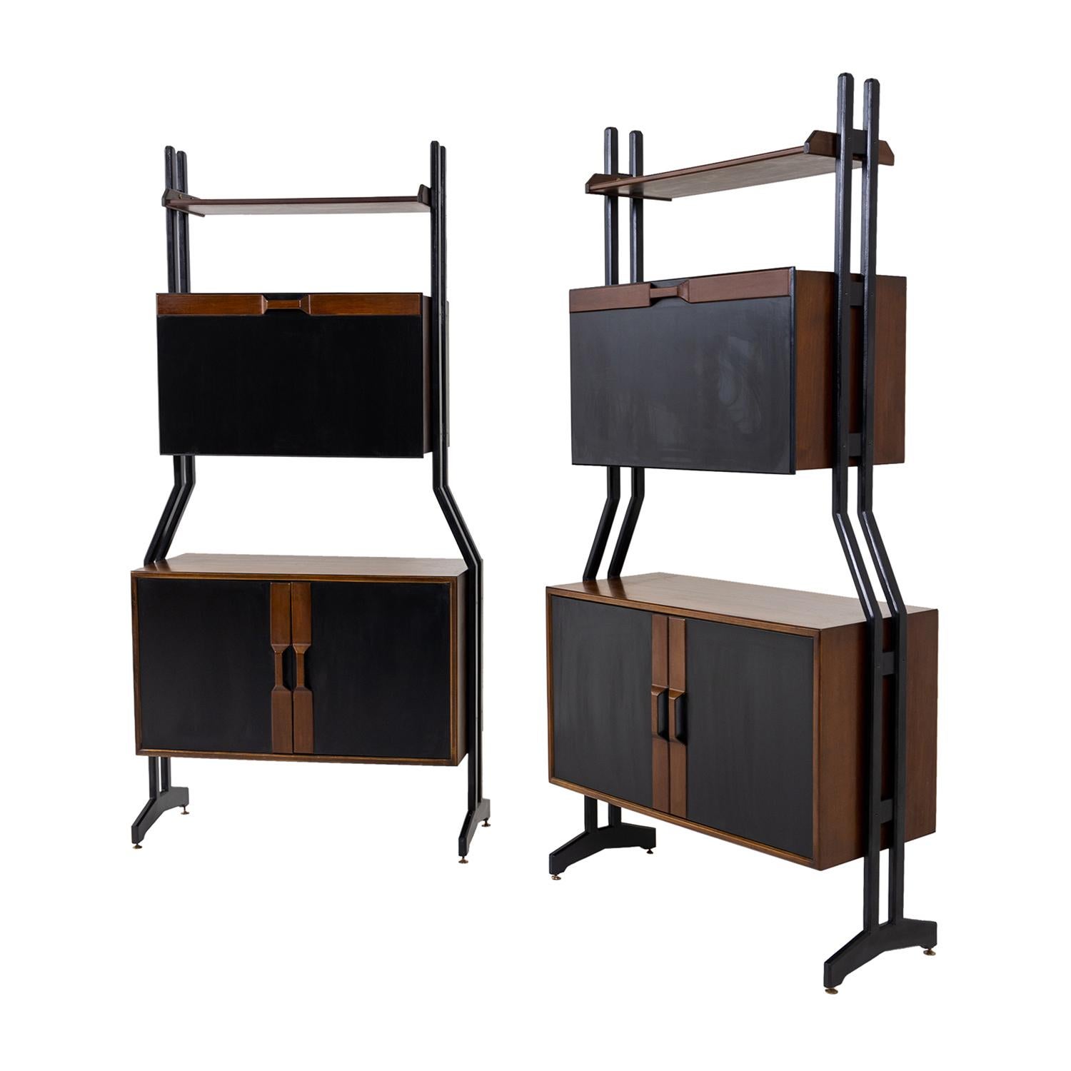A dark-brown, vintage Mid-Century modern Italian pair of slim bookshelves with a top rack made of hand crafted polished Walnut and Rosewood, designed most likely by Vittorio Dassi in good condition. The upper part is composed with a foldable door,
