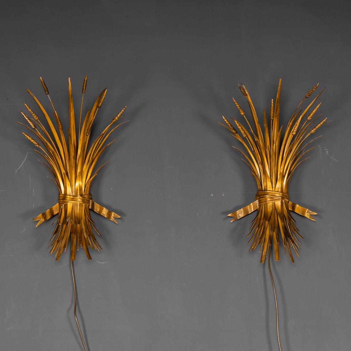 A pair of Italian gilded metal wall lights in the form of a wheatsheaf, c.1970's. Once lit they creates a rich yet soft light source, a spectacular addition to any interior whether modern or traditional.

CONDITION
In good condition - wear and