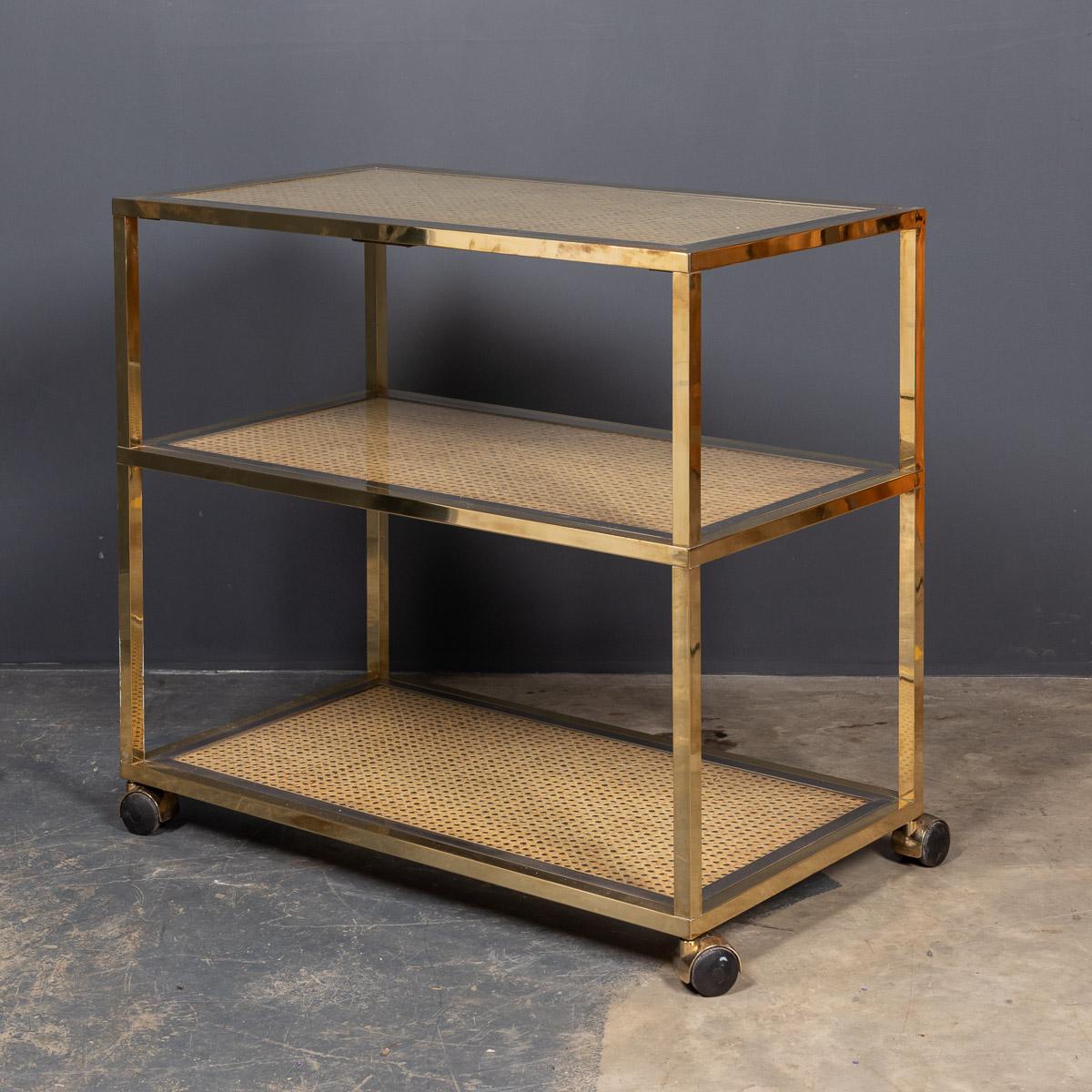 Stylish 20th century Italian three-tier brass and chrome drinks trolley with rattan and glass shelves. A must have for any sophisticated cocktail party.

Measures: Height 74cm
Width 80cm
Depth 45cm.