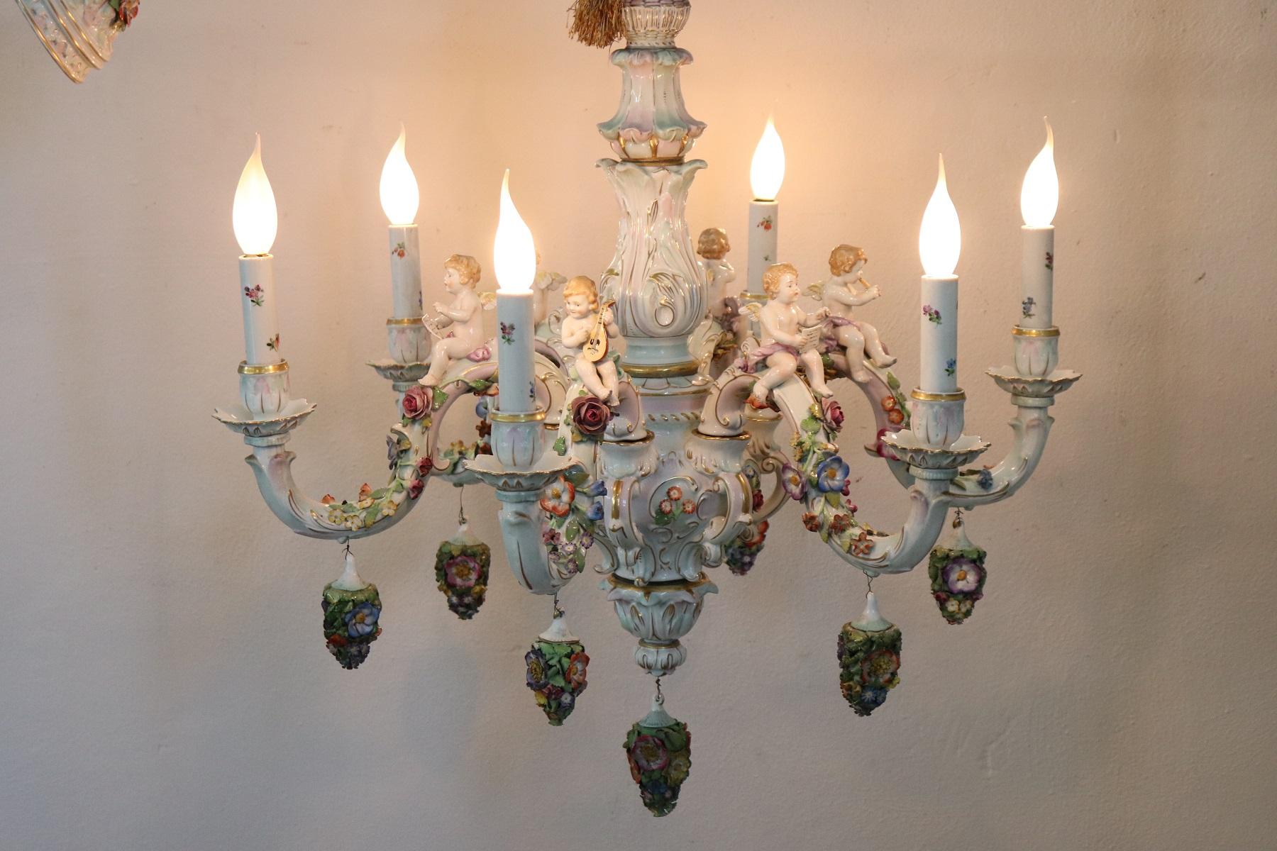 Beautiful and refined Italian chandelier six lights. This chandelier is a masterpiece of the manufacture of Cpodimonte made entirely of ceramic and hand painted. Many decorative elements make this chandelier unique, many colorful flowers sitting on