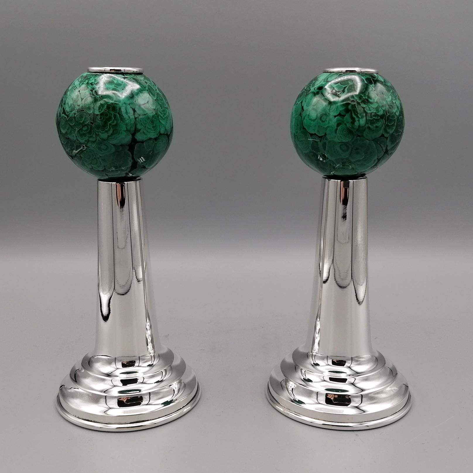 Pair of Italian candlesticks in sterling silver.
The base of the candlesticks, finished on the bottom with a disc of briar, is round with steps that make it brilliant and balanced. 
The stem is smooth and conical which ends with a ball-shaped