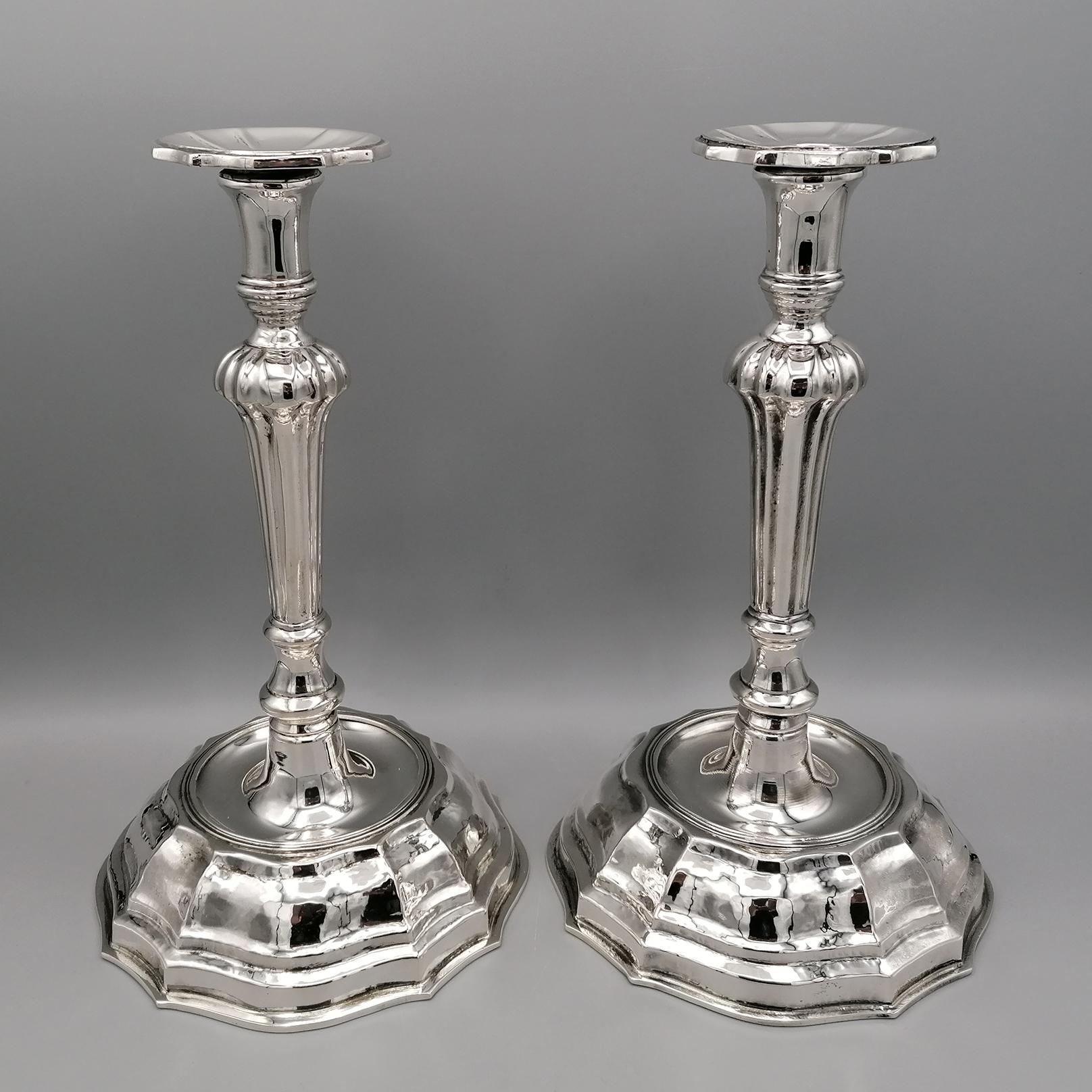 Pair of classic hand-made candlesticks in Baroque style '700.
The base is round and is made of hammered plate.
The stem is cast, grooved and chiseled finishing with the shaped wax collector. 
By Zanovello Argenteria - Padua - Italy
For Arval Argenti