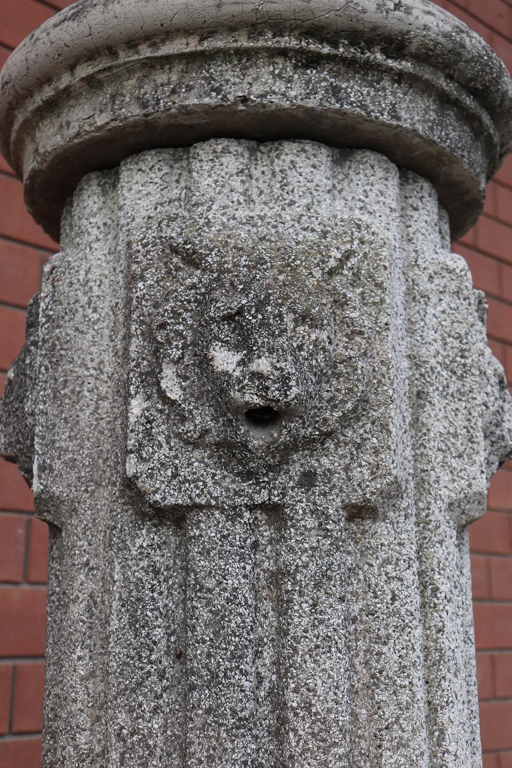 Beautiful refined garden fountain in neoclassical style, circa 1930s main material stone mixed with gravel and cement. Four beautiful lion heads from which water comes out. The stone shows signs of the passage of time. This fountain is perfect for