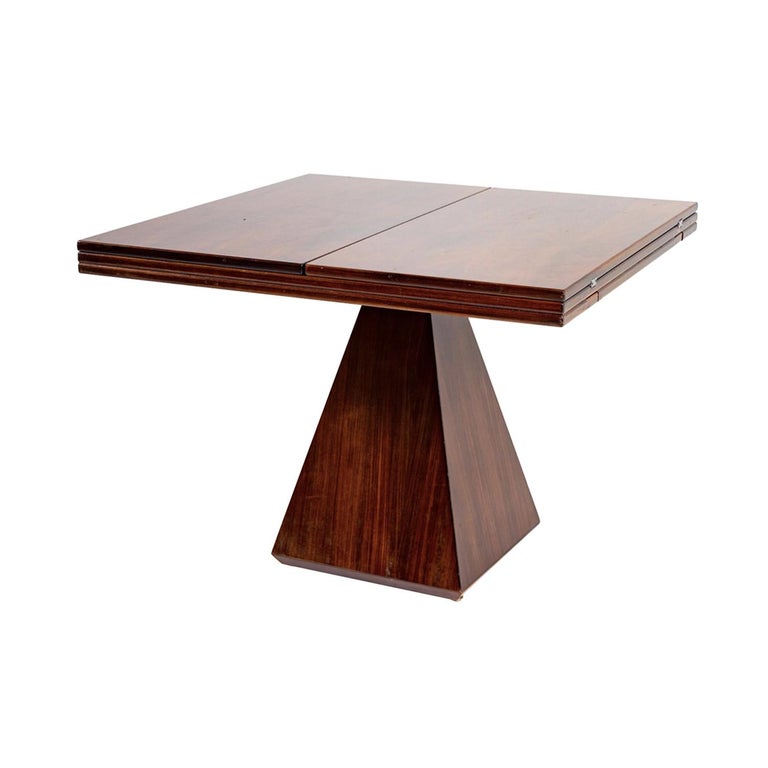 A dark-brown, vintage Mid-Century modern Italian extendable geometric dining room table made of hand crafted polished Mahogany and Rosewood, designed by Vittorio Introini and produced by Saporiti in good condition. The folding game, card table is