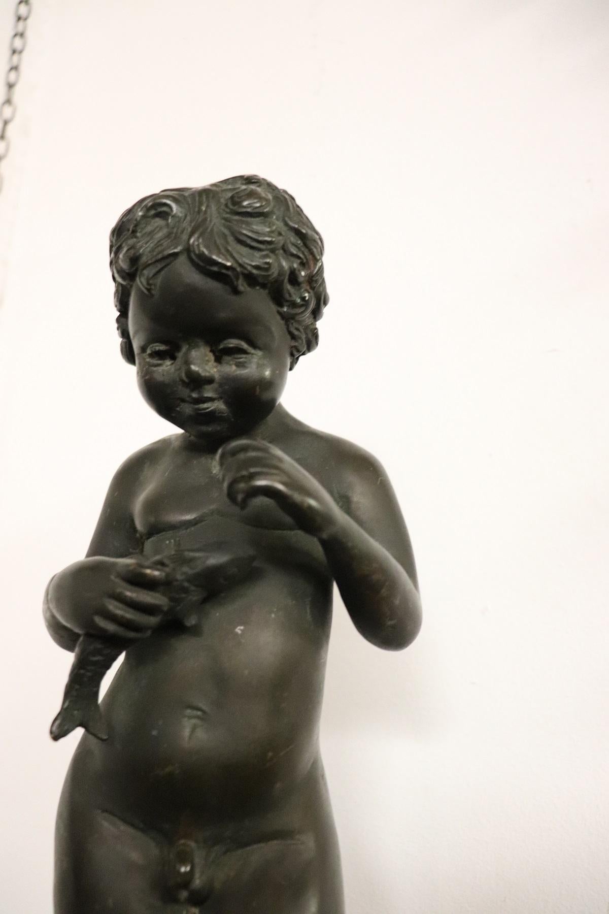 Beautiful Italian bronze sculpture. A small and sweet naked child clutching a fish to his chest. The child is made with extreme perfection. Remember the ancient Hellenistic sculptures. Bronze of beautiful patina. The sculpture is not signed.
   