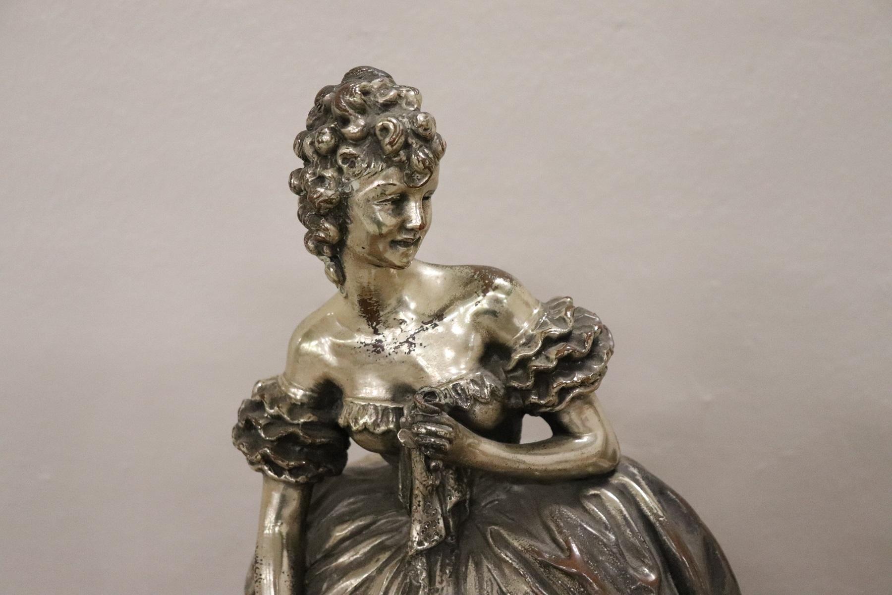 Beautiful refined sculpture in silvered clay on a wooden base. Figure of a beautiful young girl with basket and kerchief in her hand. The girl is depicted with a sweet face and elegant bearing surely it is a noble girl. The features are very fine