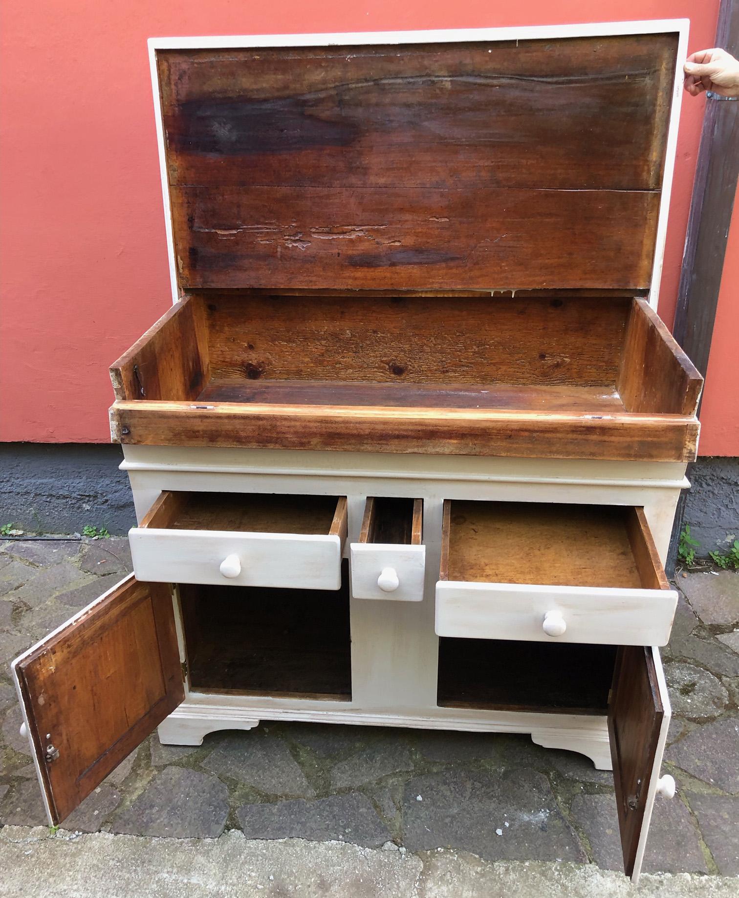 Twentieth century Italian sideboard in alder wood, external color patinated white. It is called ''Madia'' in Italian and is typical of the Italian region Tuscany. In ancient times it was a piece of furniture used to contain flour and the dough for