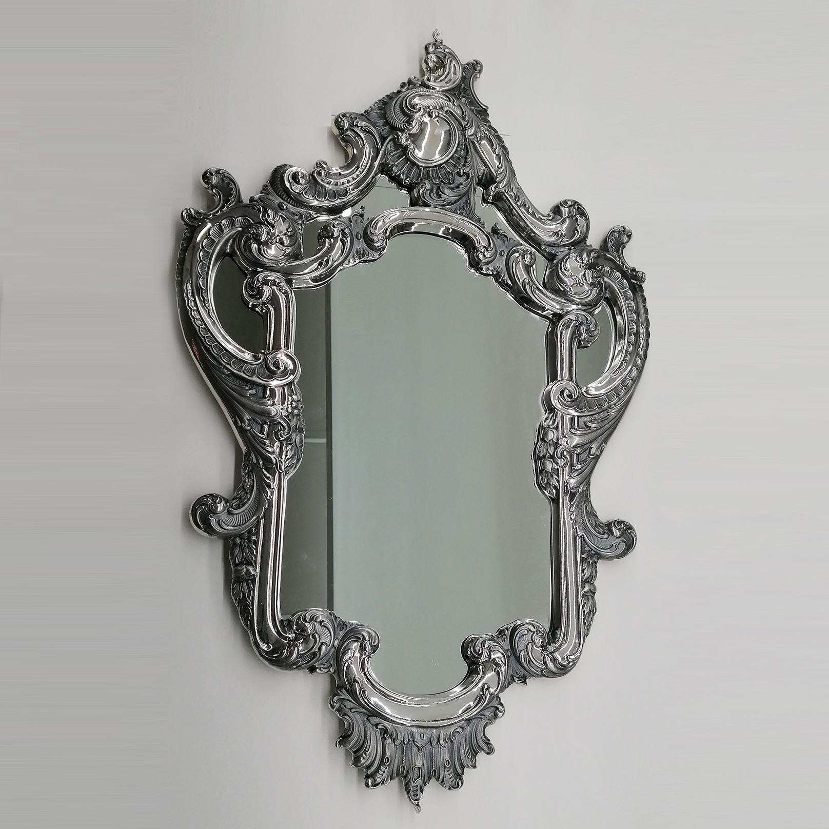 Gorgeous mirror in solid 800 silver made in Milan - Italy in the mid-1950s.
The mirror was masterfully embossed and chiselled with scrolls, shells and flowers, typical of the Baroque style.
The finish is two-tone glossy and with burnished parts to