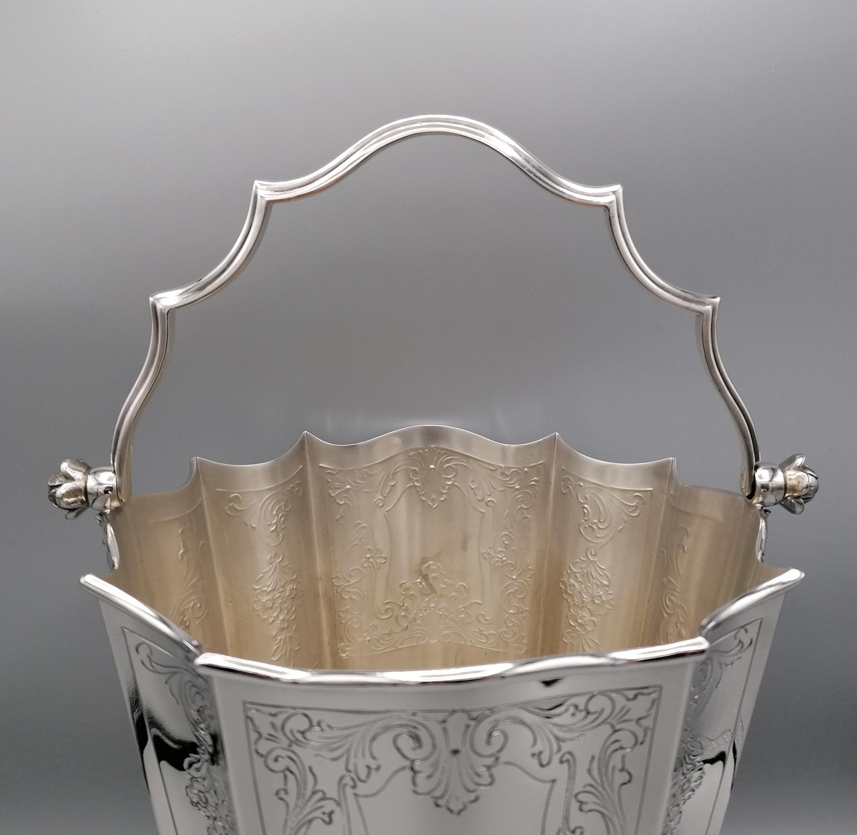 Gorgeous Baroque style silver champagne bucket completely handmade.
The body is shaped to give shape to the Classic Baroque and engraved style.
The cast tilting handle follows the shape of the body and is fixed to the bucket
with a flower screw