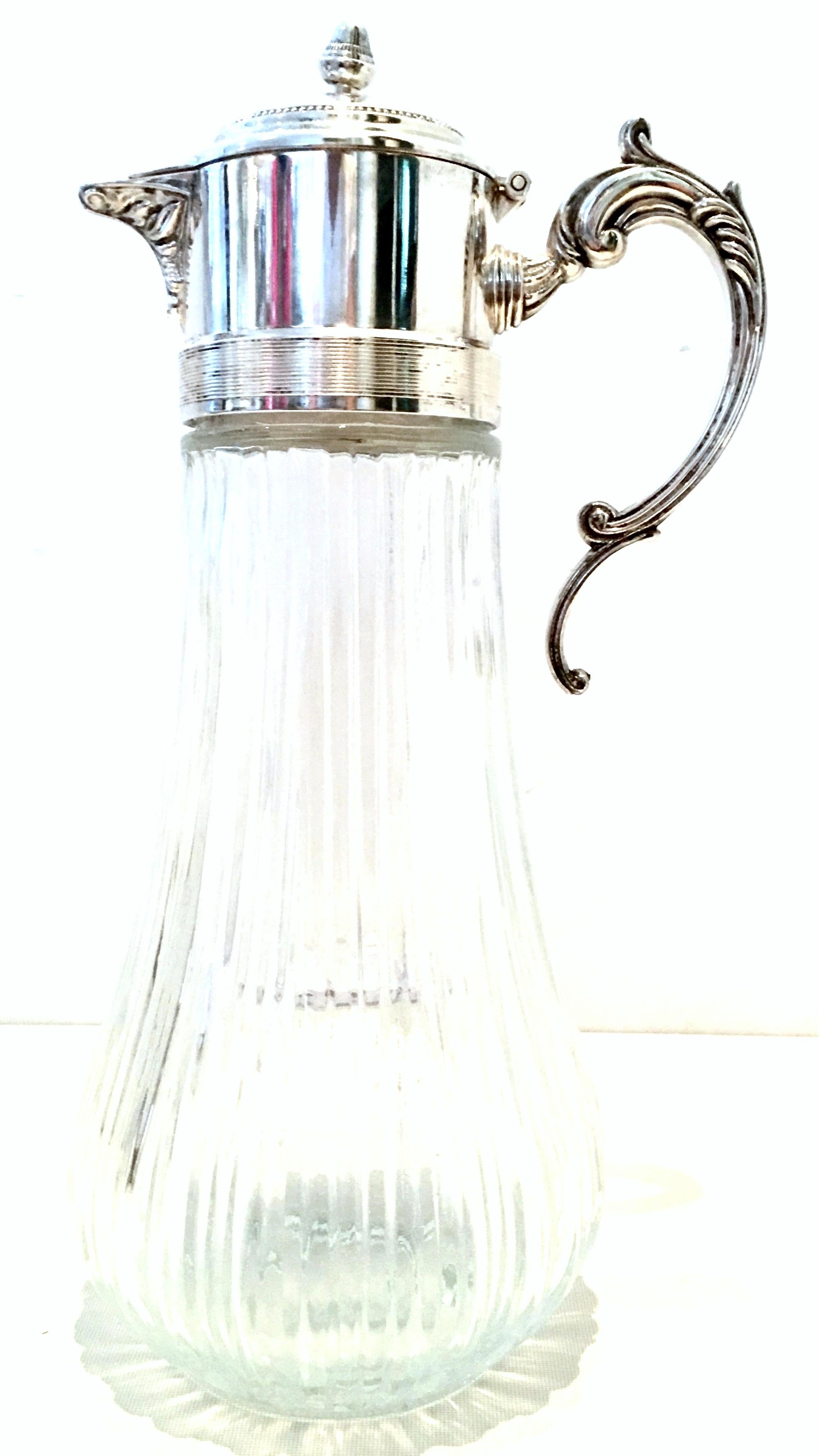 Mid-20th century brilliant cut-glass and silver plate scroll motif handle screw top claret pitcher. Includes a plastic internal infuser container. Marked on the underside of the silver plate lid, Silver plated-Italy.