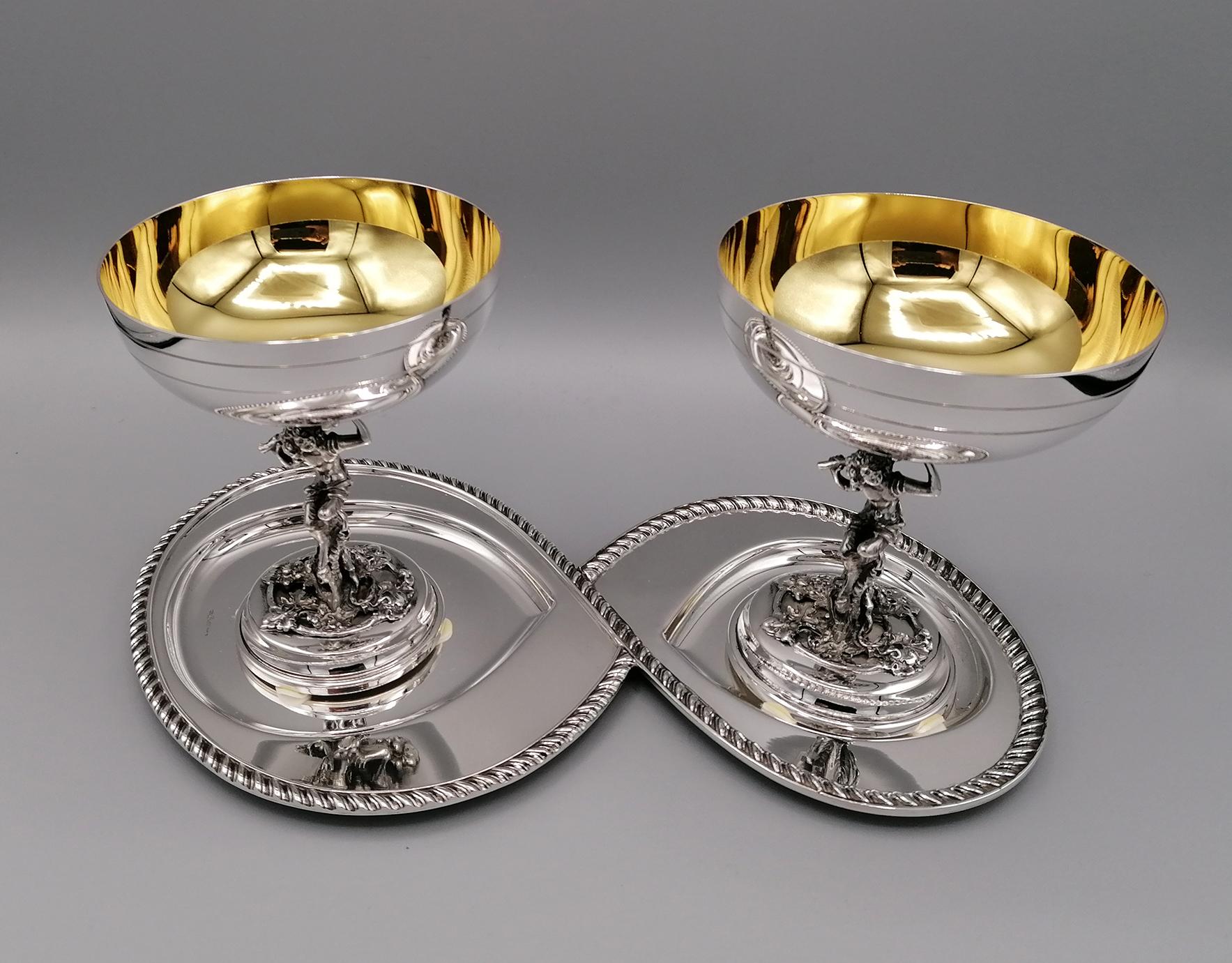 Stylized and shaped silver tray in 800 silver made to support 2 champagne cups in sterling silver.
The tray has a corded edge typical of the Queen Anne style.
Tray by Bellotto Argenterie - Padua, Italy, size: cm. 27 x 13

The champagne cups are in