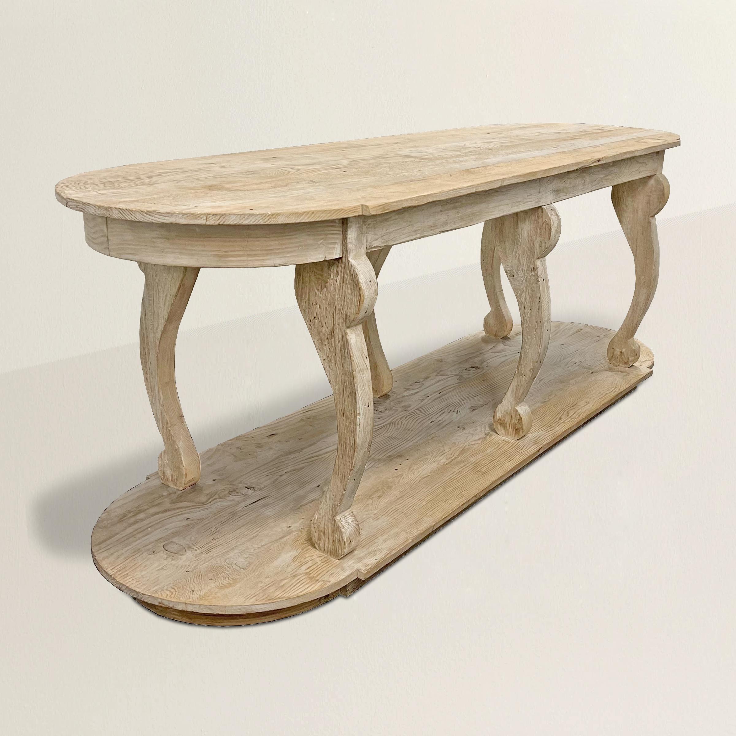 Introducing a delightful 20th-century Italian pine console table with a dash of whimsy and an abundance of personality. This quirky piece is sure to captivate with its unique design and charming features. The table boasts six distinctly curved legs,