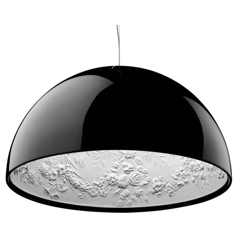 Skygarden is a suspension luminaire providing diffused light from its half-dome diffuser. The inside is white, cast plaster with an intricately designed garden pattern, the bulb is covered by a detailed opal glass diffuser and the outside is made in