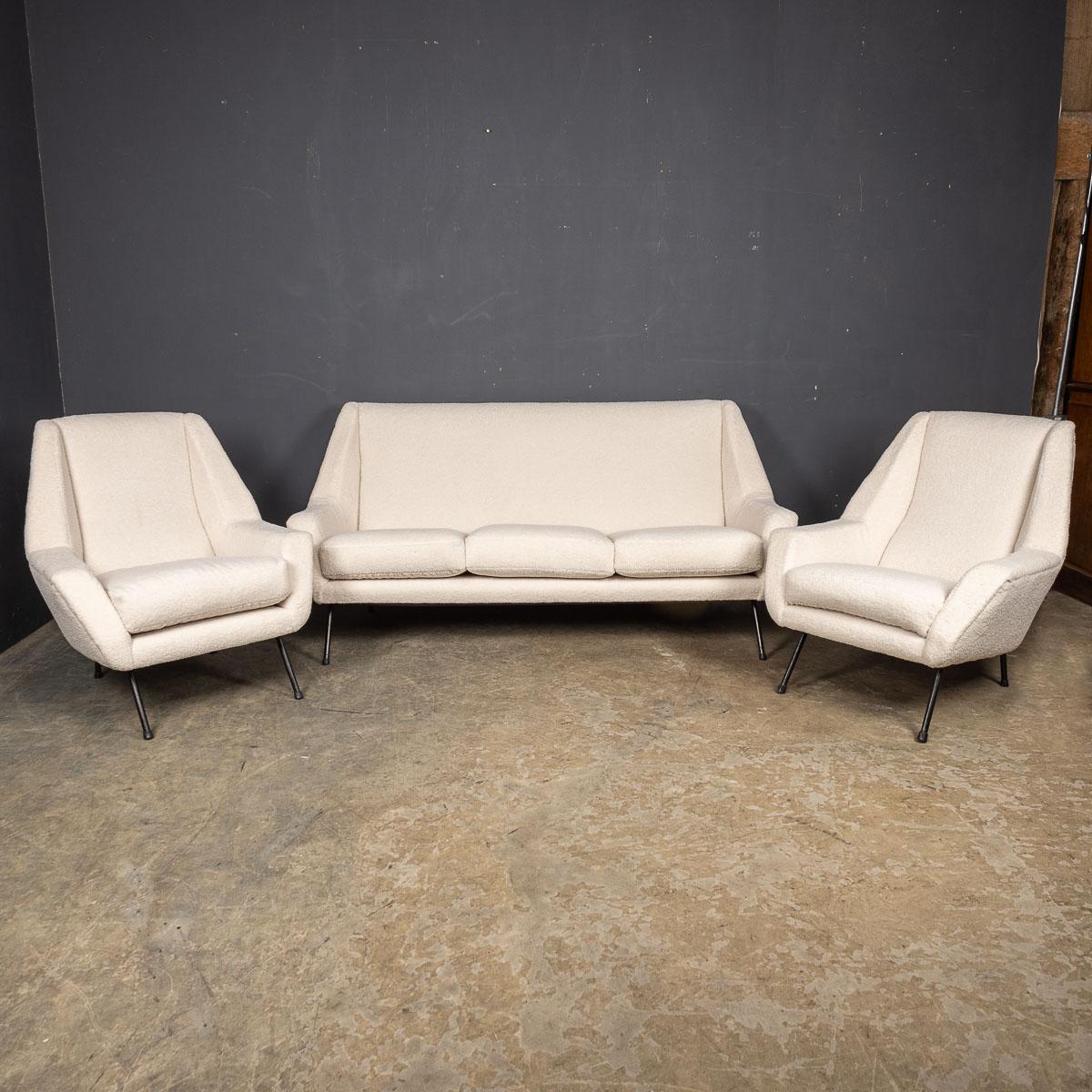 A stunning ensemble of mid-20th Century Italian sofa and armchairs, each featuring elegant metal legs and skilfully reupholstered in a luxurious cream boucle fabric with removable seat cushions. These pieces boast exceptional craftsmanship and are