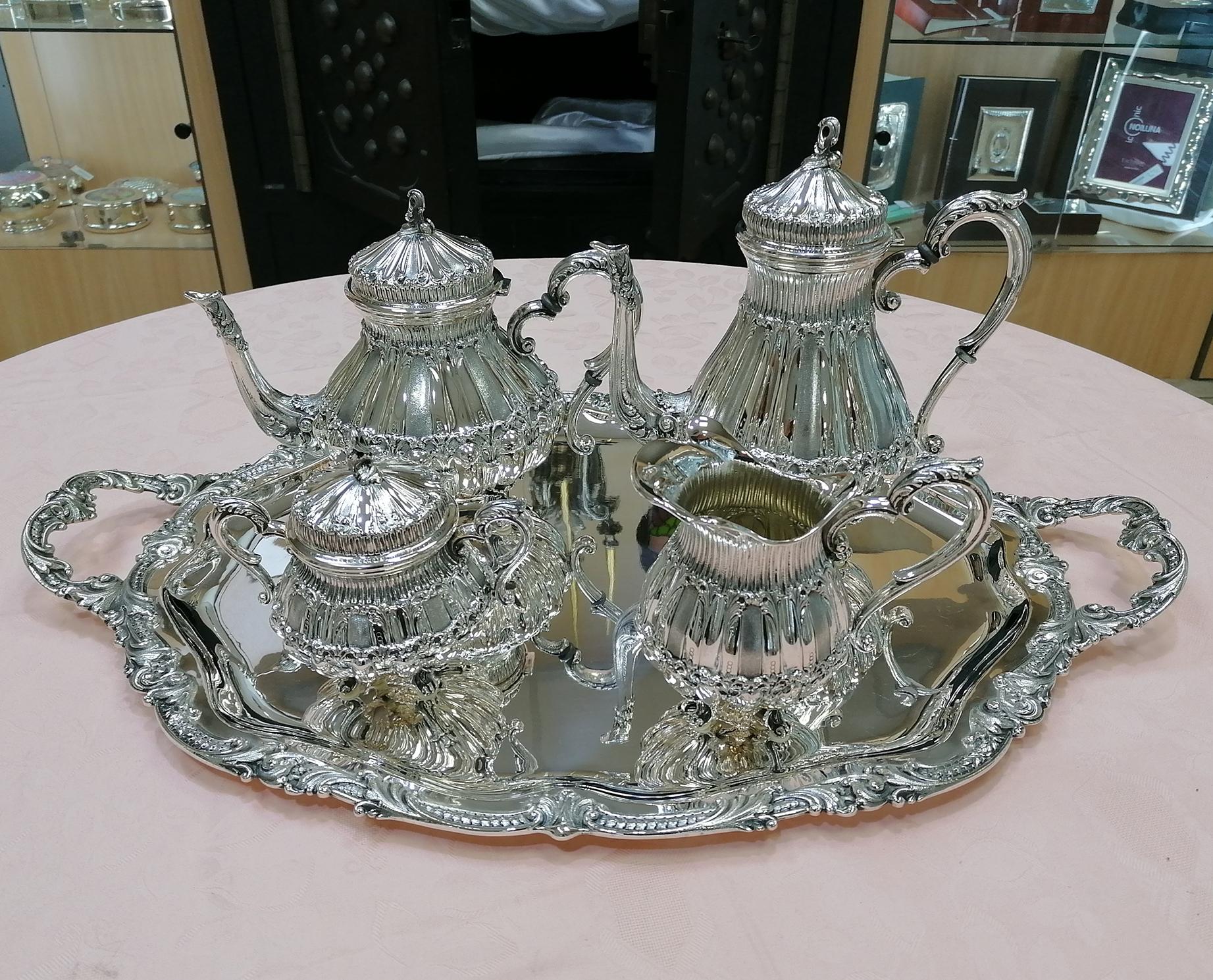 Italian tea and coffee service and tray made entirely by hand in the 40s of the 20th century. 
The service is round and each piece has 4 cast feet for support. 
The body is embossed and chiseled into 