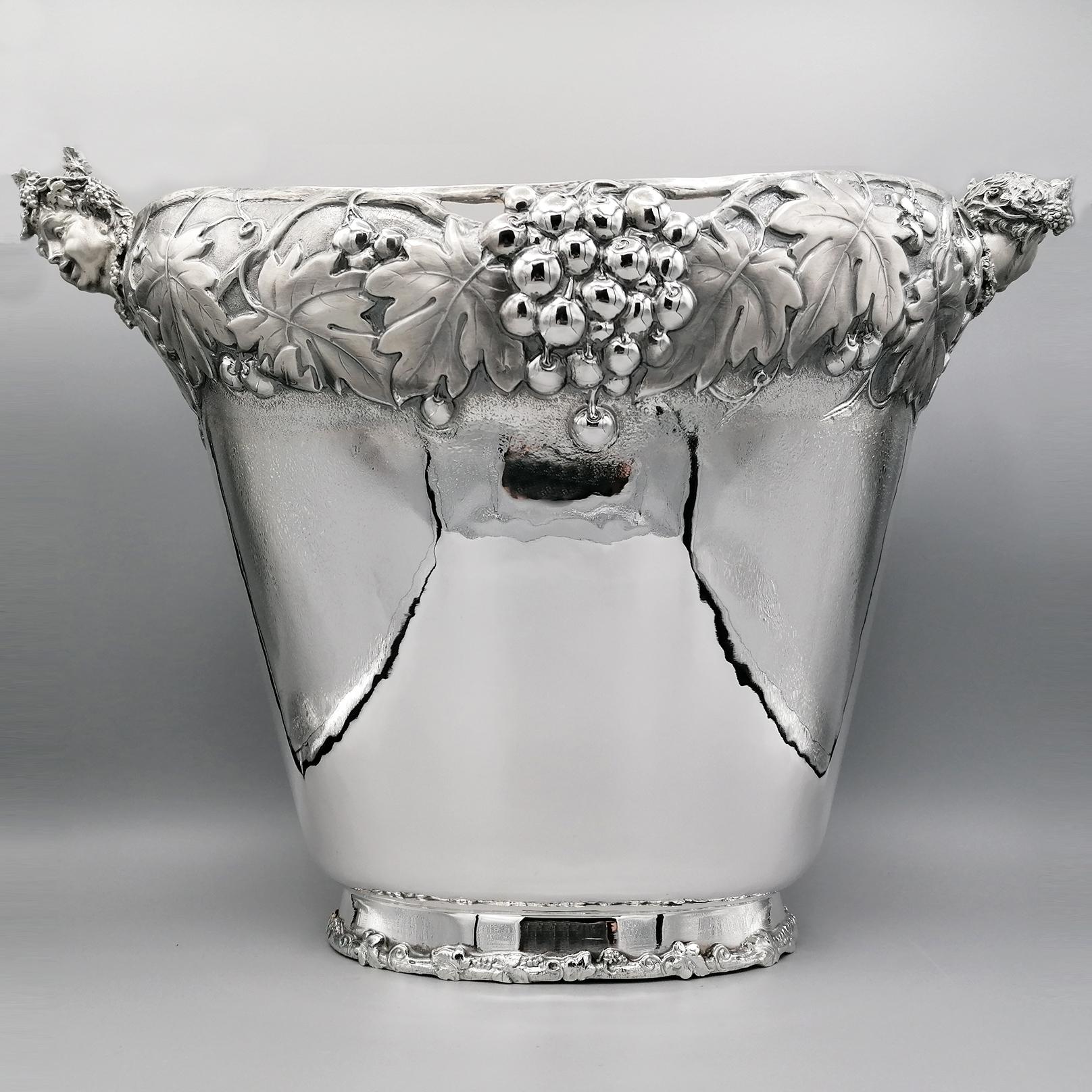 Large champagne bucket in 800 solid silver.
Completely handmade, it was made by hammering a silver plate and giving it the shape of a 2-seater champagne bucket,
The upper barrel was then later embossed, symmetrically reproducing bunches, shoots and