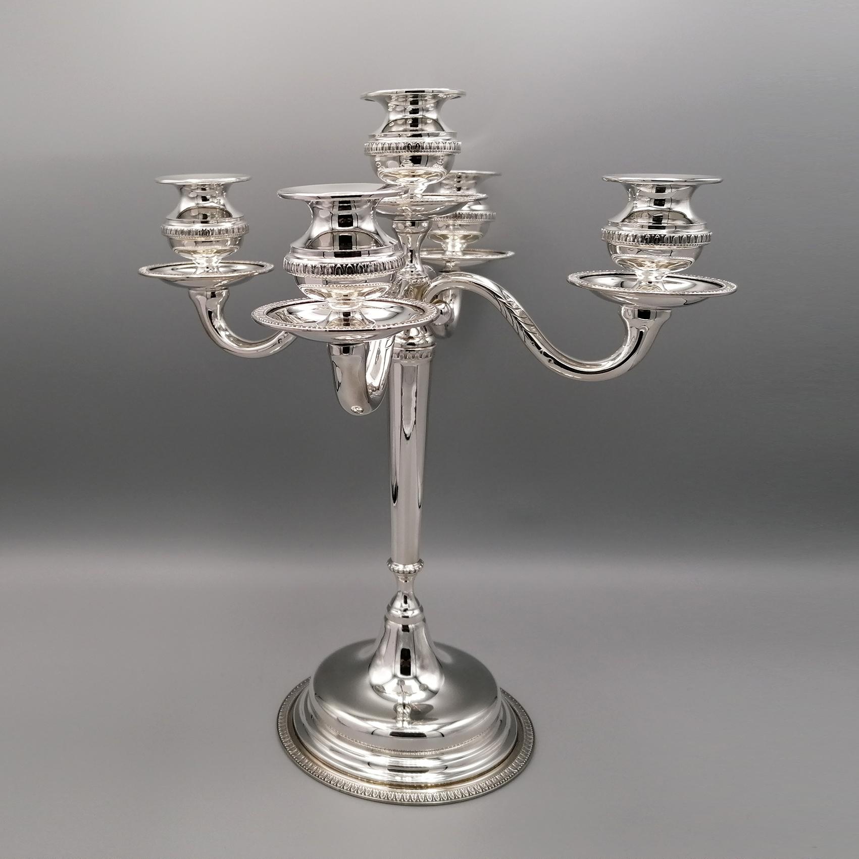 Empire style solid silver candelabra.
The border is welded on the base, on the wax collectors and on the candle holders.
The candleholders are screwed and detachable to facilitate cleaning of the candlestick.
A light chisel with a leaf design