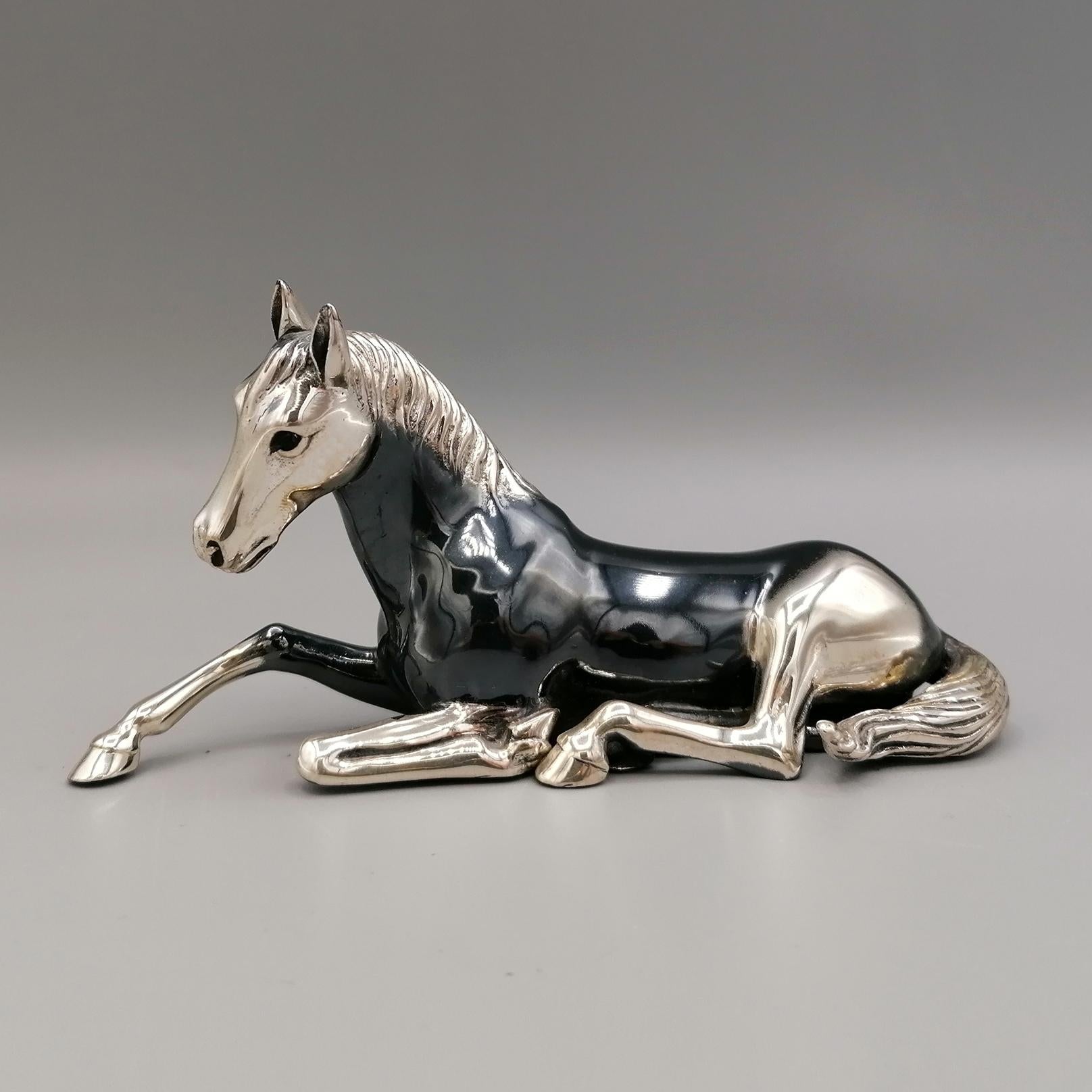 Horse figurine in 800 solid silver.
The object was made with the technique of fusion in two halves and subsequently joined by welding. 
In the lower part of the statuette you can see the two holes made to let the welding vapors escape.
The horse's