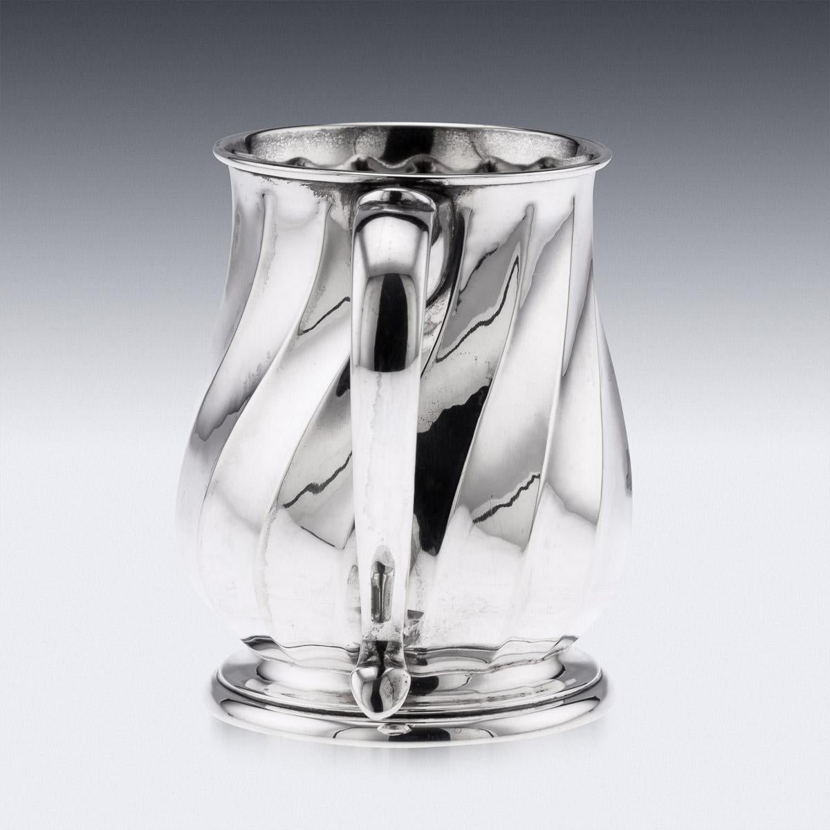 Stylish mid-20th century Italian solid silver mug, of traditional size, baluster form, the body decorated with a twisted fluted decoration and mounted with a c-shaped handle. Hallmarked (800 silver standard), city of Padova (PD).

CONDITION
In