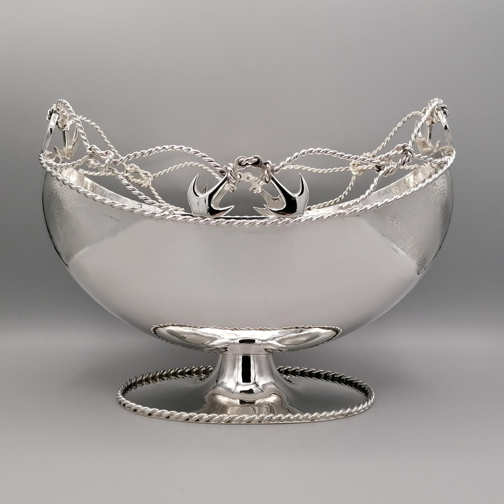 Solid silver centerpiece. 
The body is hammer-drawn oval and handmade from the silver sheet. 
The upper part of the body is decorated with silver wire twisted as a rope that forms drawings of nautical knots.
To the wire which make up the upper