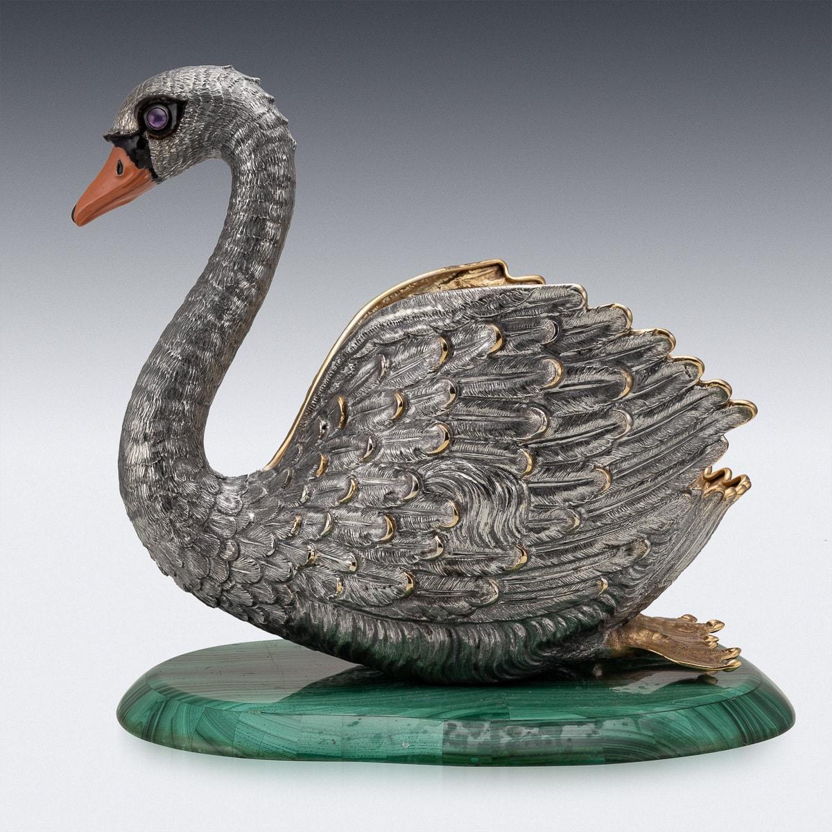 Elegant 20th Century Italian solid silver jardiniere or wine cooler, swan shaped, crafted in solid silver this magnificent swan champagne wine cooler, has an enamelled beak and glass eyes, richly gilded inside, sitting on a large piece of malachite,