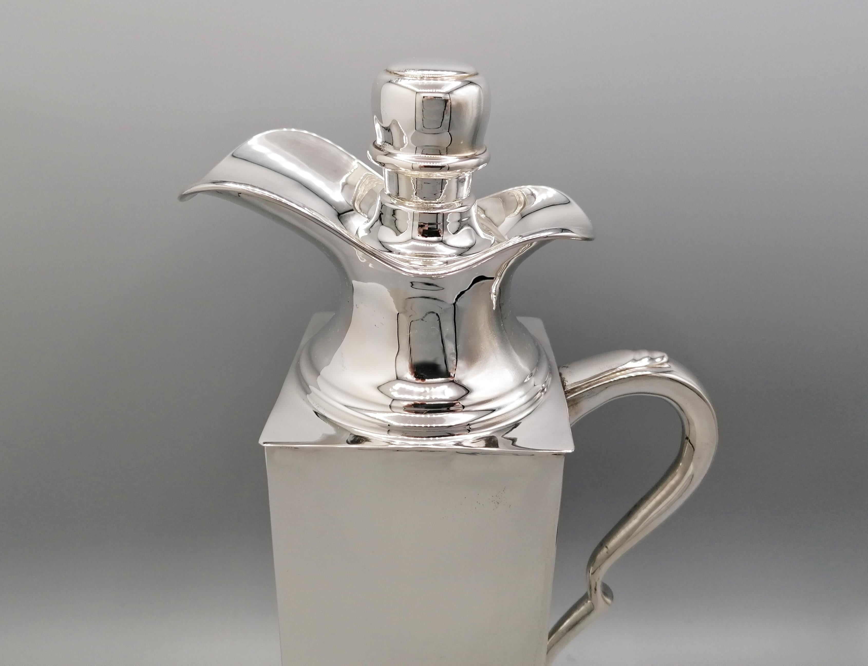 800 solid silver thermo jug made entirely by hand from the silver sheet. The body is square and developing it in its height forms a parallelepiped. The spout is shaped to allow the liquid to flow down. Inside there is a removable bottle that can