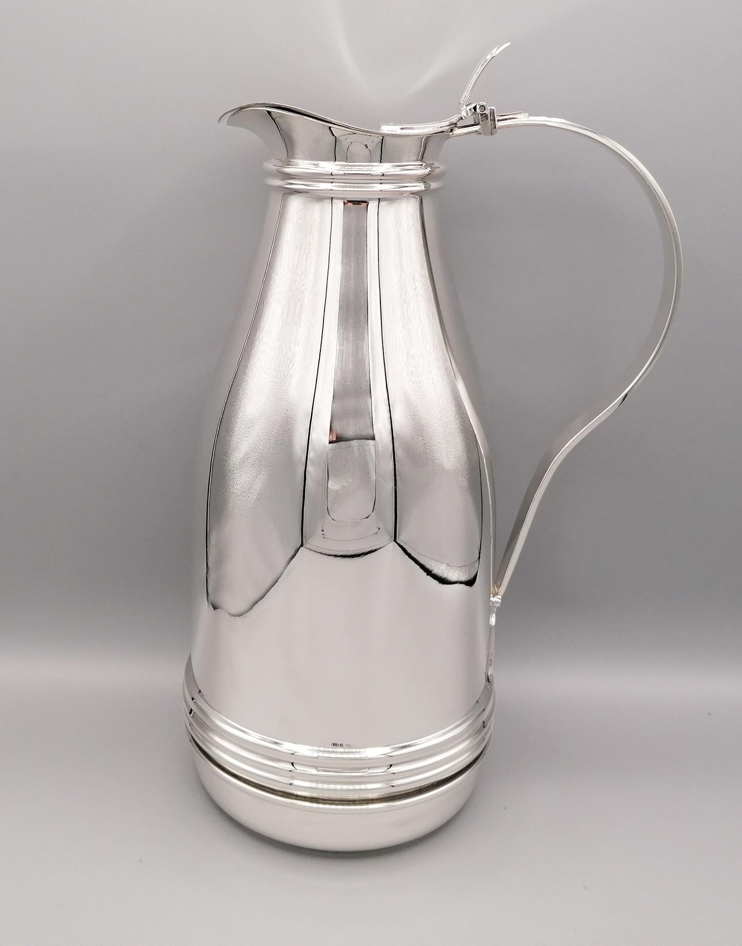 800 silver thermo jug in solid Art Deco style made entirely by hand from silver foil. The body is round and developing it in its height narrows in diameter. The spout is shaped to allow the liquid to flow down and closed with a shaped and hinged