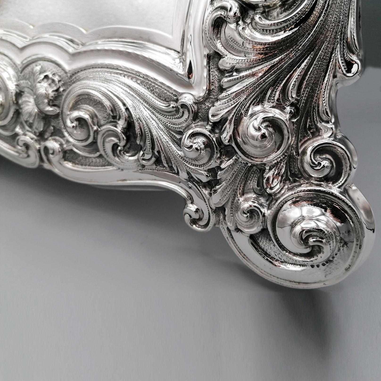 Impressive table mirror in sterling silver completely handmade in the Baroque style.
The embossed workmanship is exceptional for its craftsmanship, precision and elegance.
In the upper part, between the scrolls and the flowers, the classic Baroque