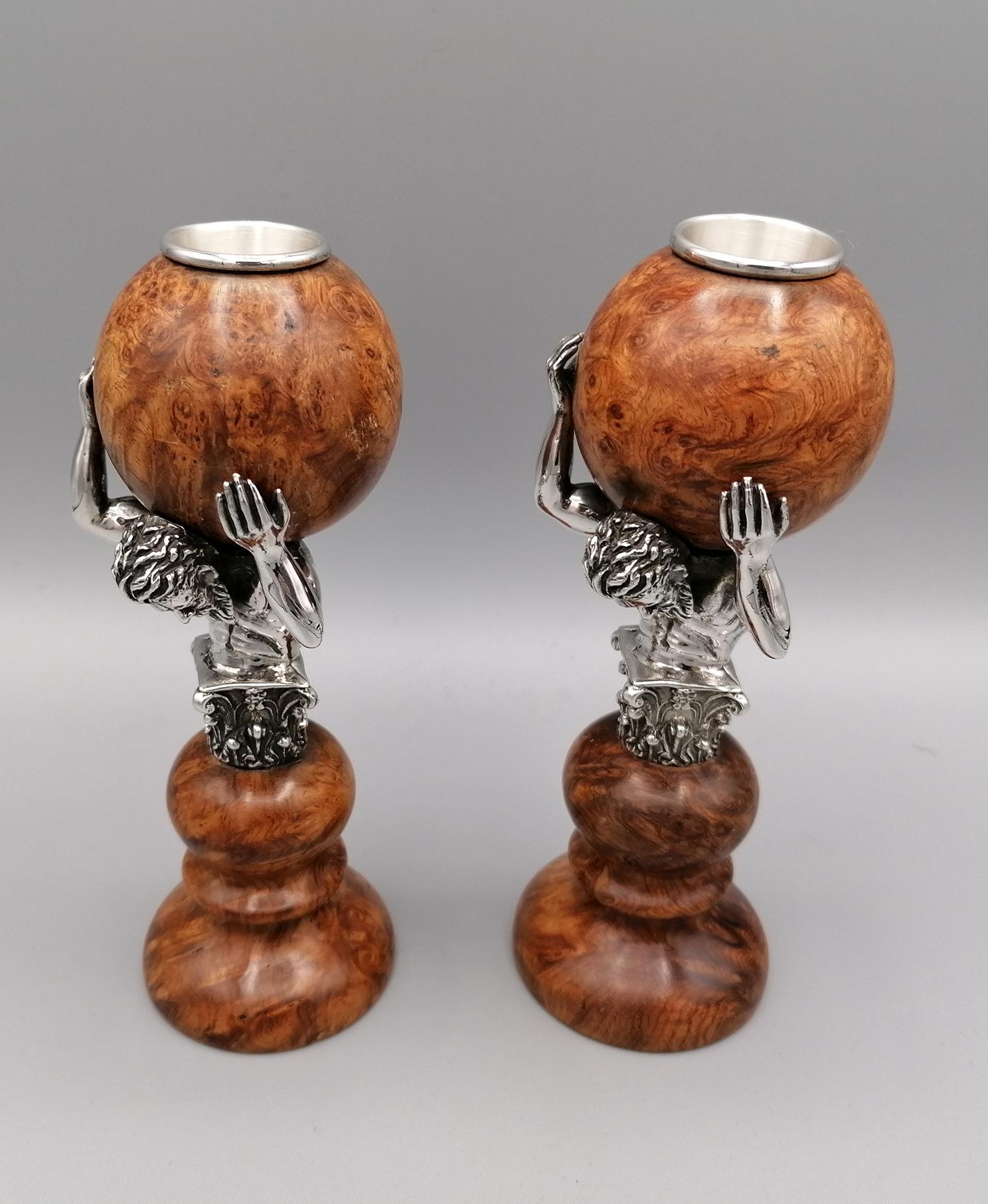 Pair of sterling silver candlesticks, depicting Hercules holding the world.
The figure of Hercules and the candle holder are in 925 silver while the world and the base are in rutinia briar.

Italian silverware, already with a centuries-old