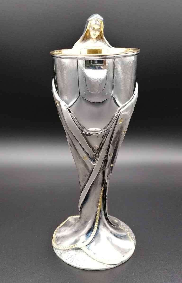 Chalice in 925 sterling silver made in cast and embossed and chiseled completely by hand. The figure of the Virgin Mary has a coat, burnished and oxidized in 2 shades, which surrounds the golden cup and is finished with 24-karat pure gold plating,