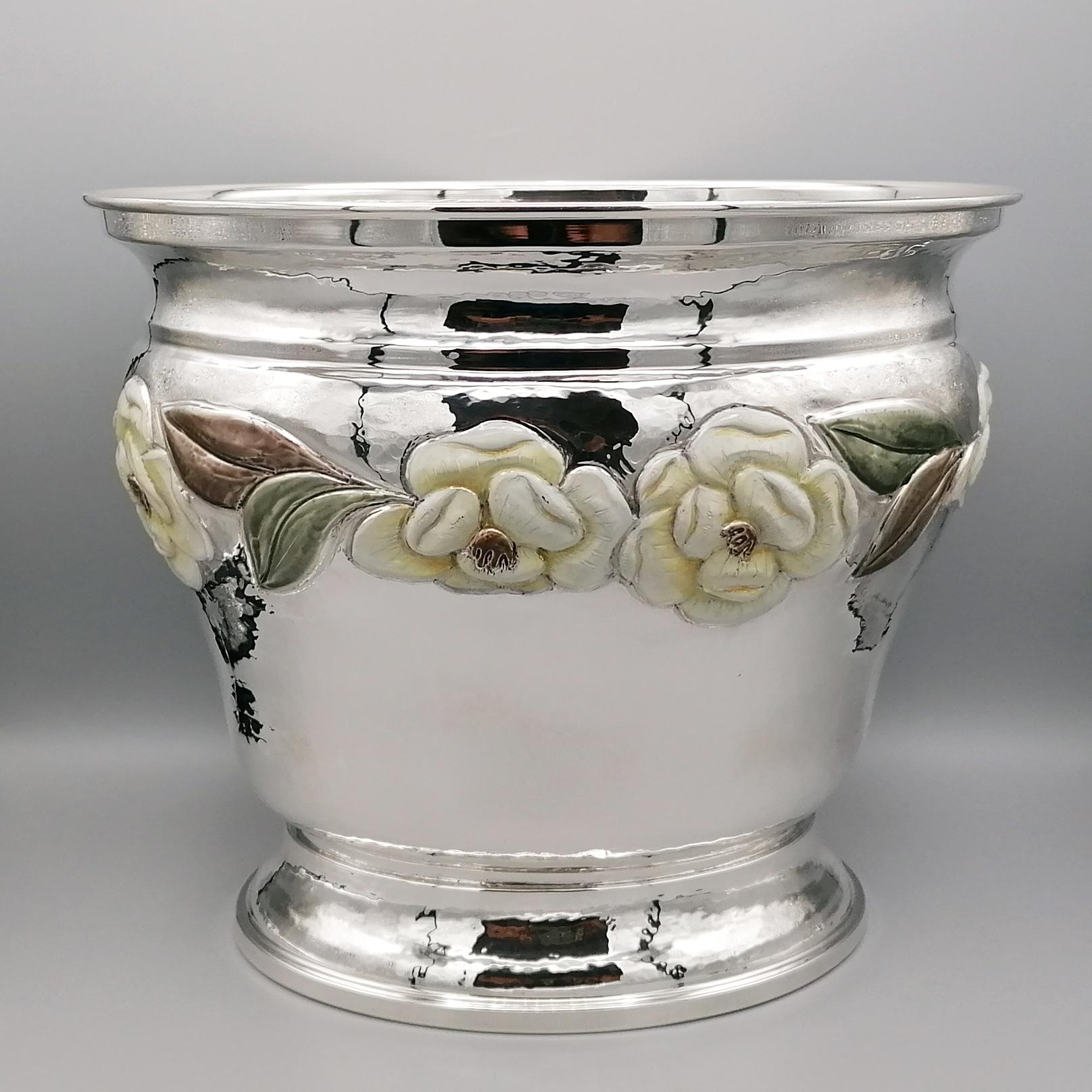 Oval shape solid sterling silver champagne bucket.
The bucket was made entirely by hand starting from a silver plate of adequate thickness, then having to emboss and chisel floral motifs.
An oval base was placed under the main body of the bucket