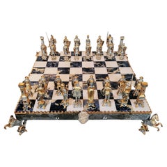 At Auction: A large ornate chess set with sterling silver board. Board  measures 46x46x8cm