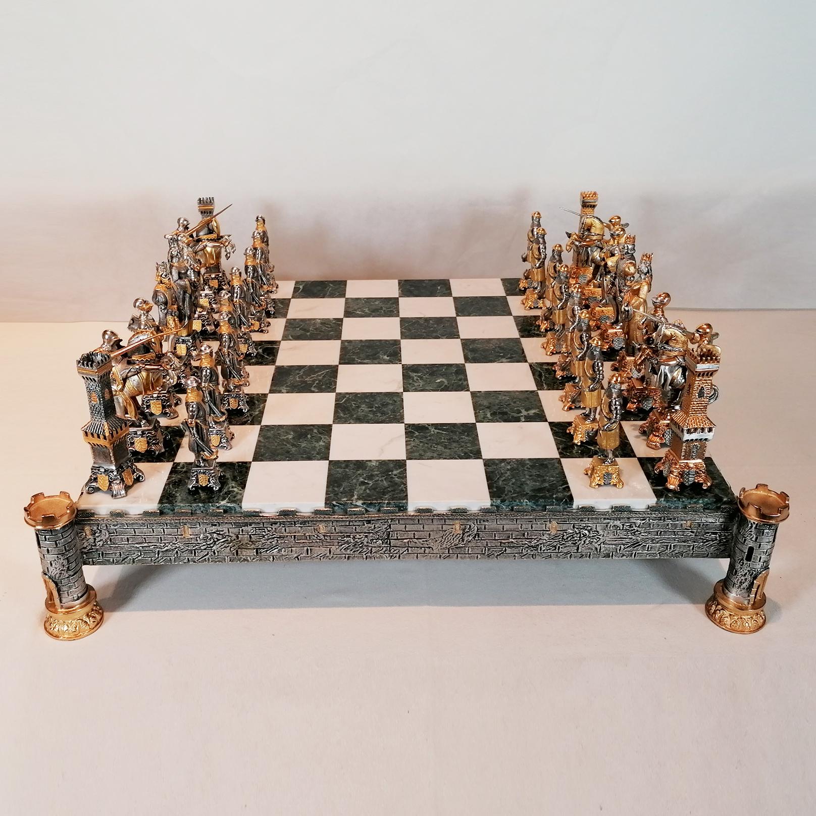 Impressive Sterling Silver Chess Board and Silver Plated Medieval Style Chess Set.

The chess board, made by Arval Argenti Valenza, was made in white and green marble and is supported by a STERLING SILVER frame made with the casting method and