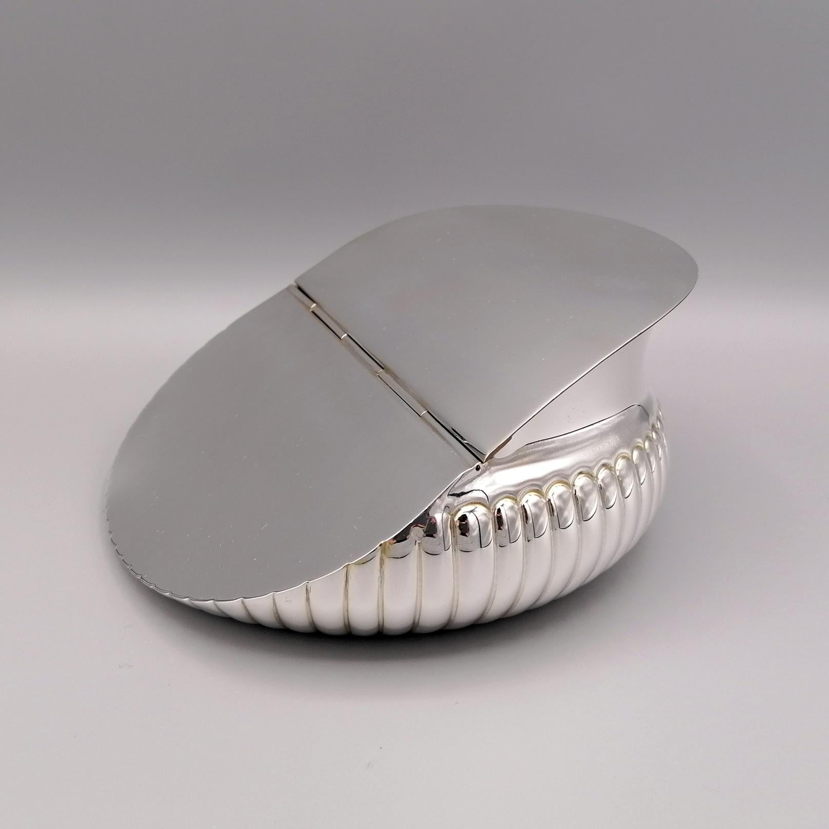 Completely handmade solid sterling silver decorative box of oblique shape. 
The lower part of the body has fluted embossed and chiseled
The smooth, glossy lid is hinged in the center.
Italian silverware, already with a centuries-old tradition, had a