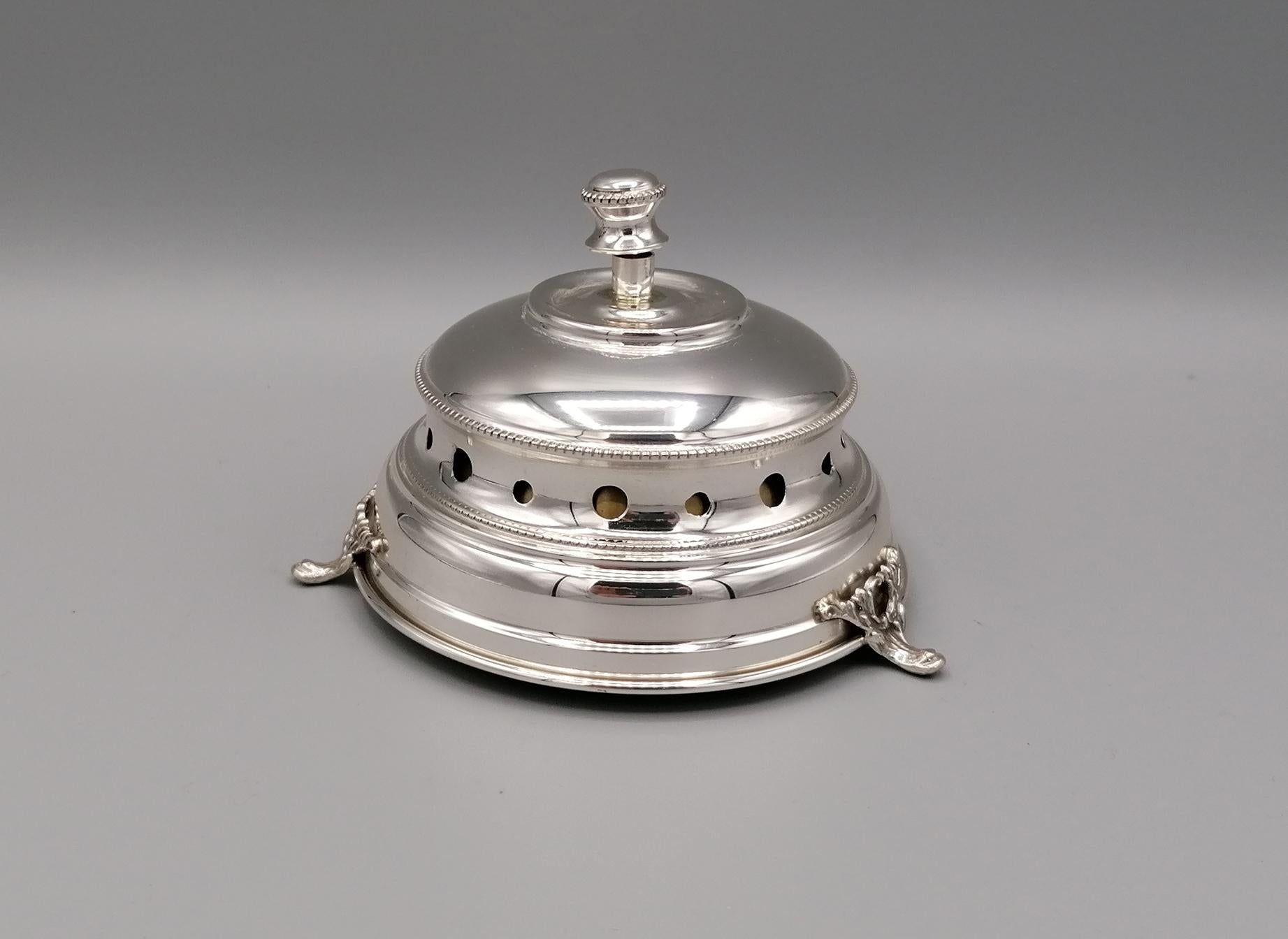 Desk bell in sterling silver. The bell is smooth with beaded decorations both on the body and on the knob.
The body is perforated to make the bell sound (brass movement) more ringing.
The object is placed on 3 full plates always made of silver