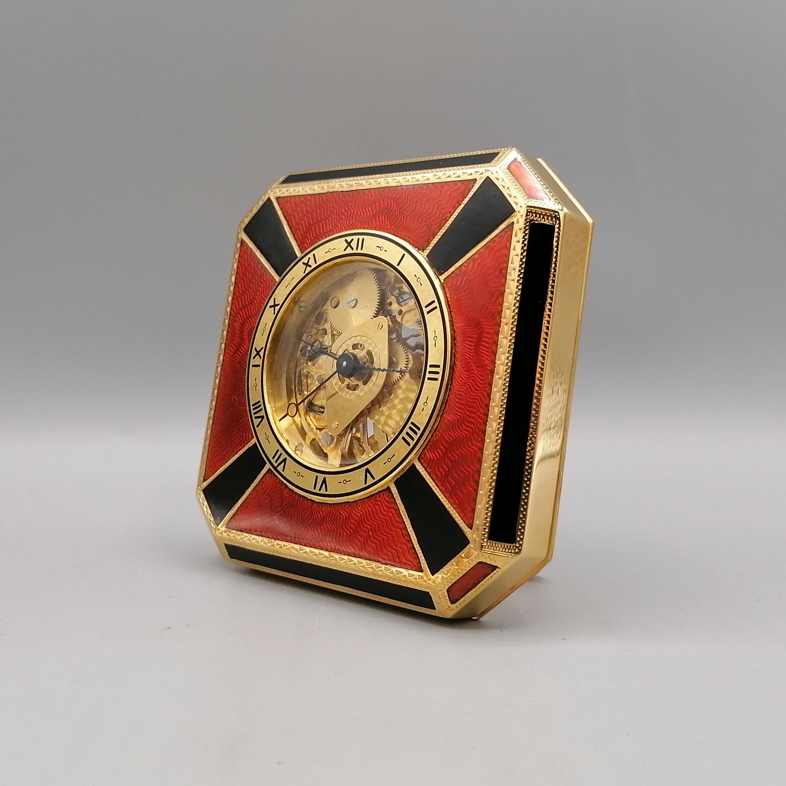 Art deco octagonal table clock cm. 10x10 in 925/1000 gilded silver with translucent black and red fired enamels on guilloché, Swiss mechanical skeletal movement, winding 8 days

The miniatures are hand-painted on a usually white homogeneous enamel