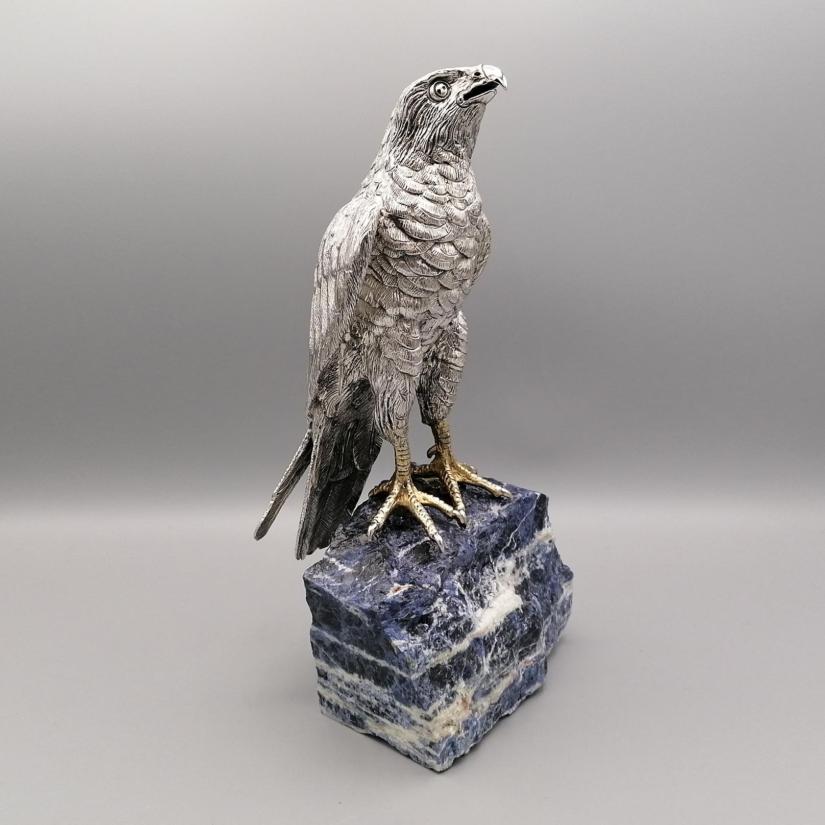 Hawk in sterling silver on a sodalite stone-base.
The hawk was made in casting. The finish was made completely by hand with chisel and engraving.

The reproductions of animals in solid silver, especially hawks, eagles and horses, had a great