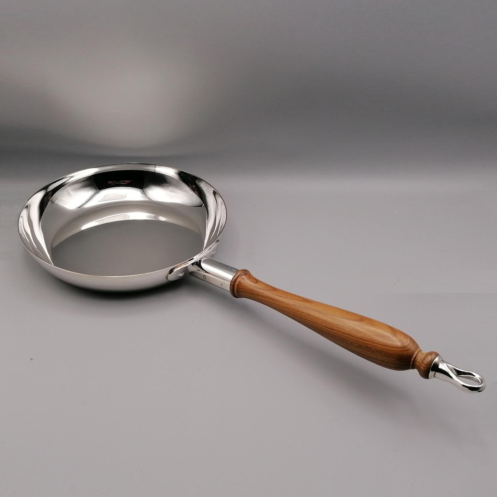 Unusual sterling silver ornament with wooden handle in the shape of a frying pan. A tube, also in sterling silver, was welded to the round and smooth part, interspersed with a wooden handle and a silver ring finish to ensure that the object can be