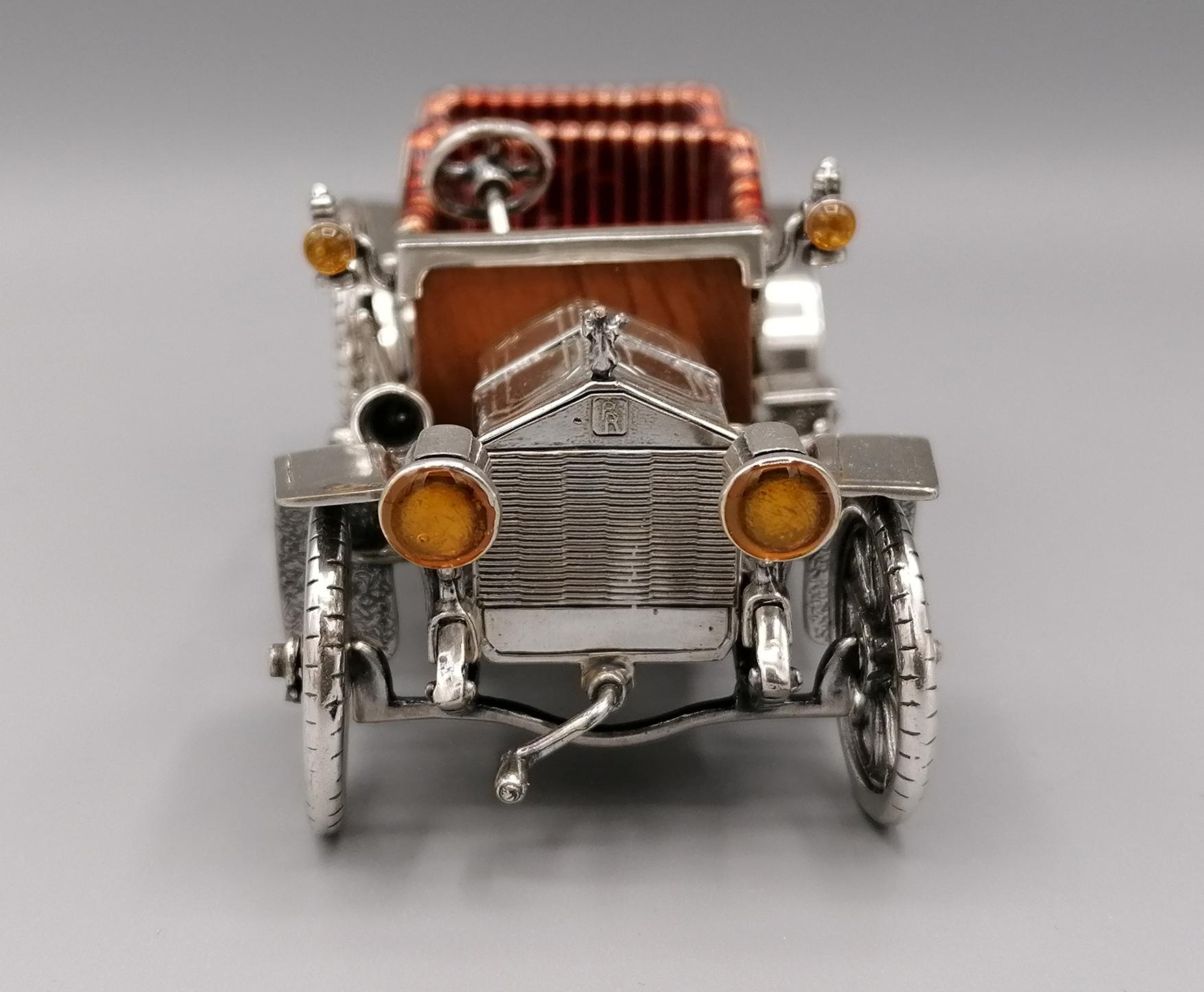 Handmade Rolls Royce car sterling silver model.
The details of the dashboard and the car floor are in briar wood.
The seats are enameled.