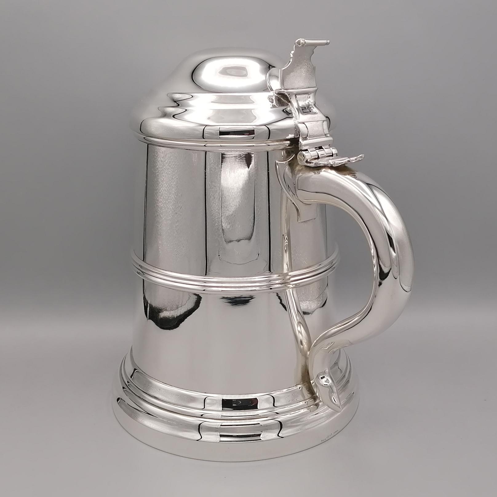 Sterling silver lidded big and heavy tankard in a George I style, having a plain straight-sided body with an applied reeded band, a hinged dome lid with thumb-piece, a scroll handle, and sitting on a reeded collet foot.
Italian silverware, already